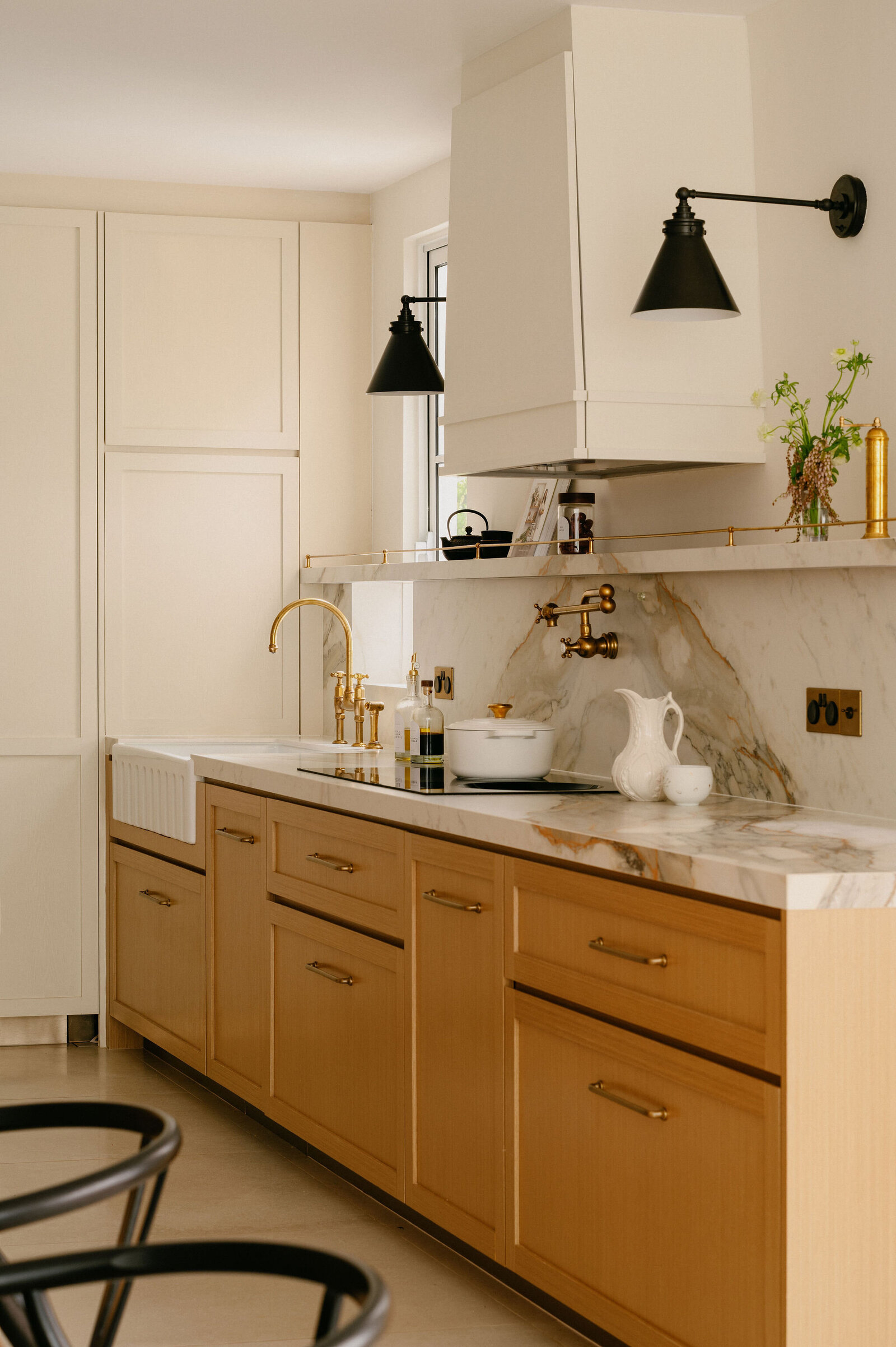 Sink and countertop area of a farmhouse-inspired kitchen, interior design by Haus Atelier, with custom cabinetry.
