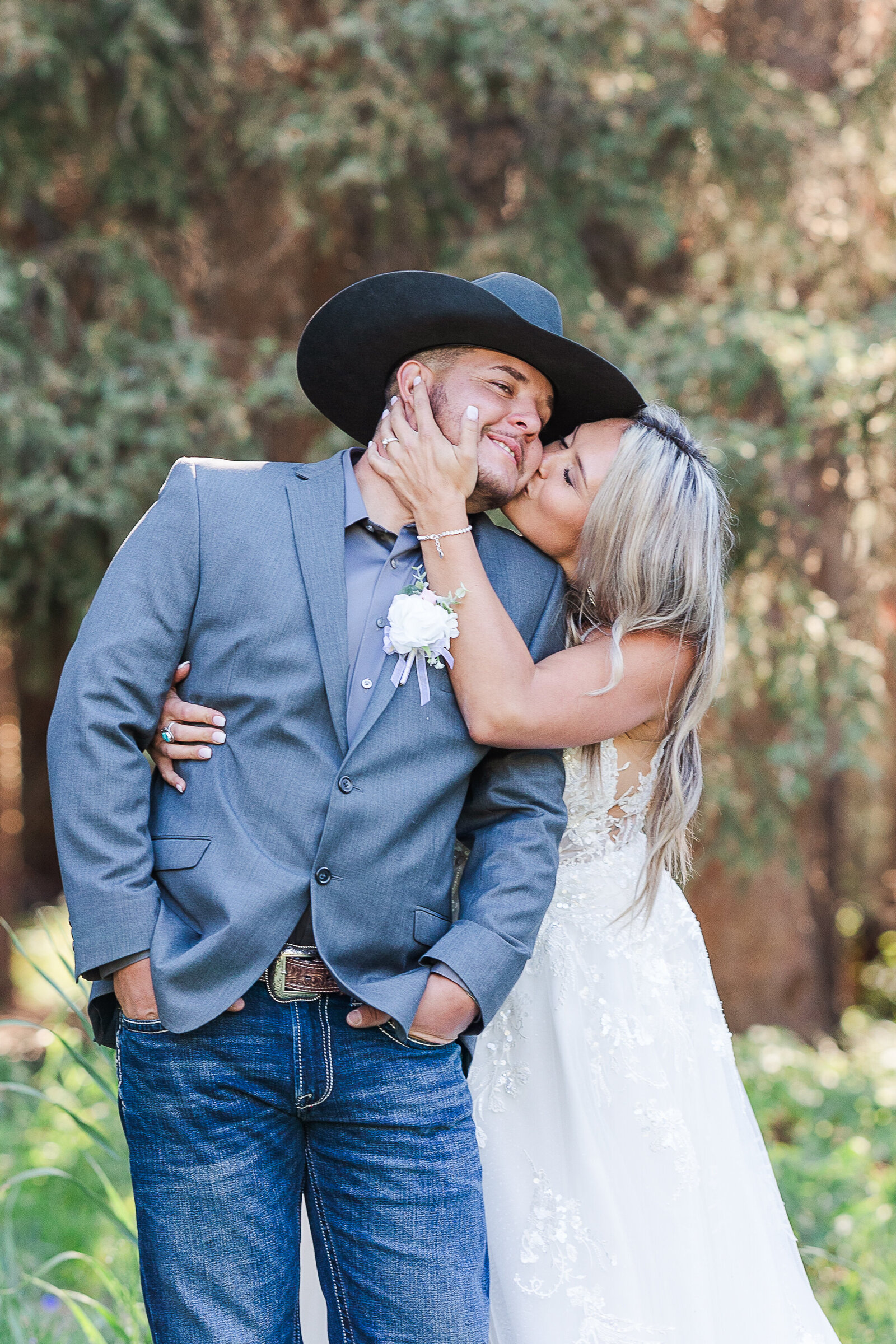 Bride holds grooms cheek in this sweet photo of the bride and groom on their wedding day