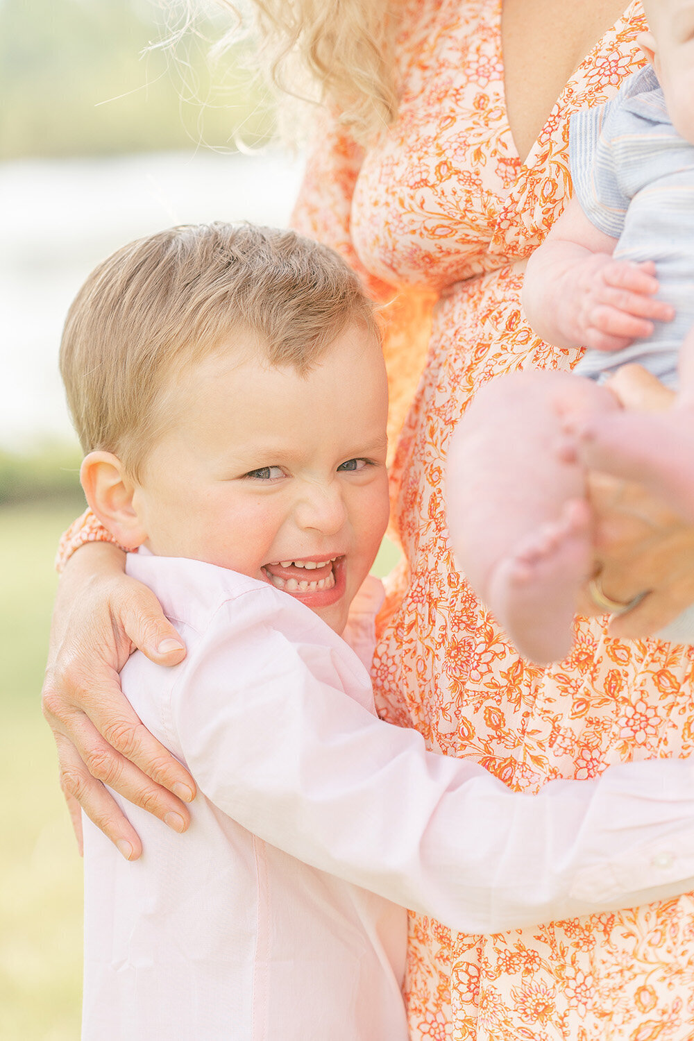 boy hugs mom while laughing during spring minis in Springfield, Virginia