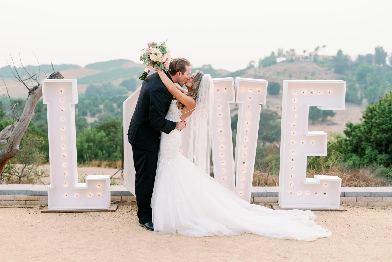 Bride and groom with Love sign, Temecula photography