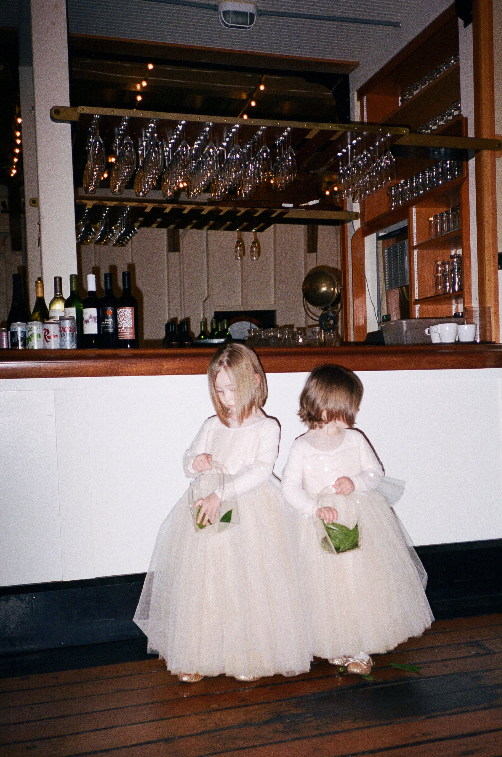 Flower girls entering the ceremony in matching dresses at The MV Skansonia in Seattle.