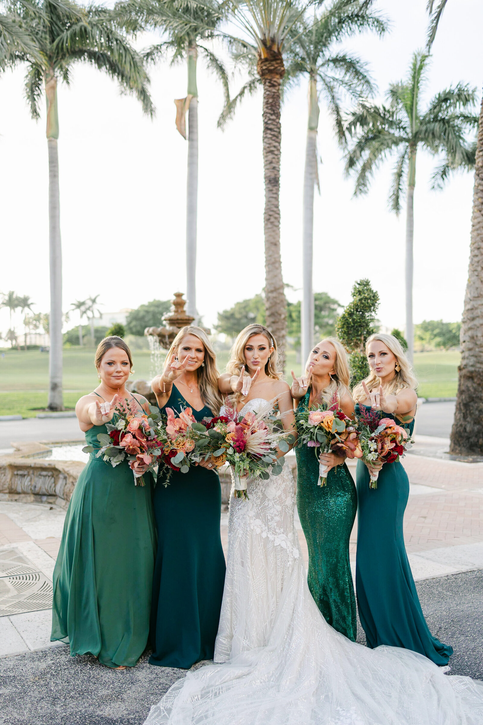 Bride and her Bridesmaids posing outside at the Boca Raton Resort in Boca Raton, Florida. Photo by Maggie Alvarez Photography