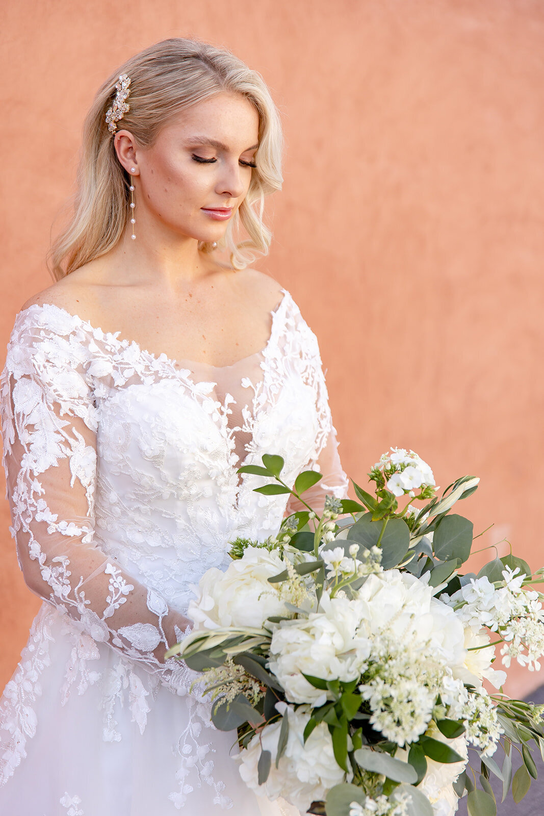 bride looking down at her wedding flowers
