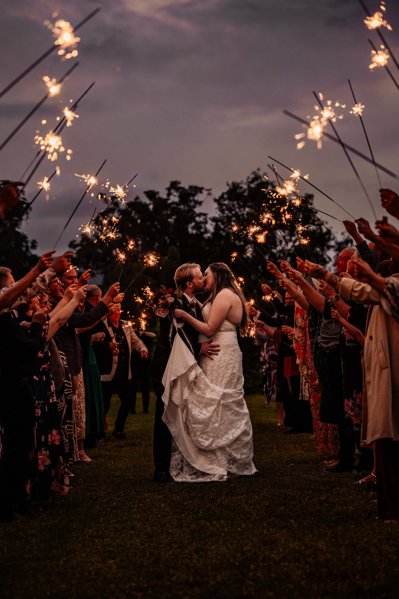 A display of wedding sparklers igniting in the night, enhancing the romantic ambiance of the special occasion.
