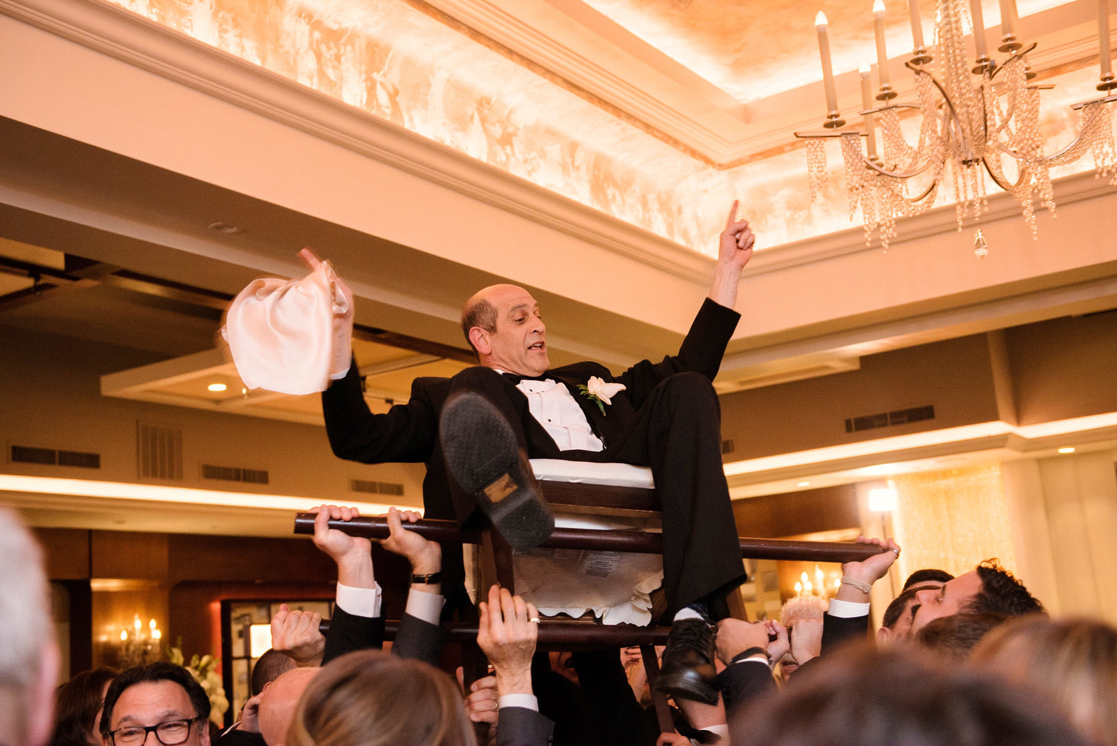 Father of the bride on the chair during the Hora