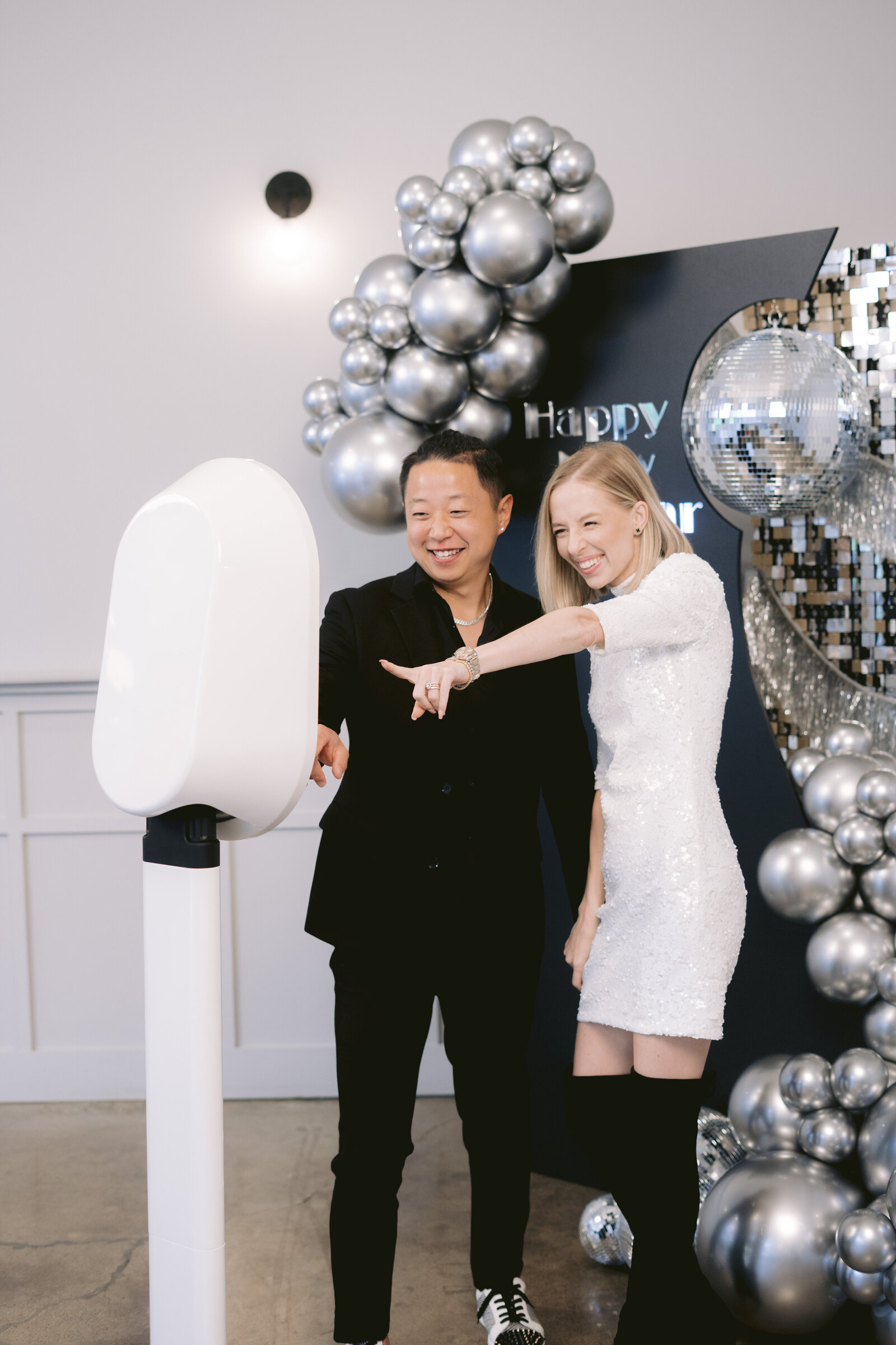 Bride and groom posing together in the photo booth at their wedding reception