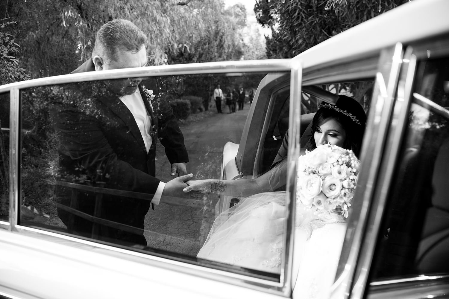 dad helping bride out of car at ceremony