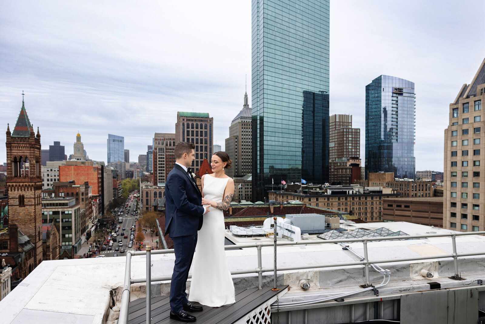 bride and groom on boston rooftop