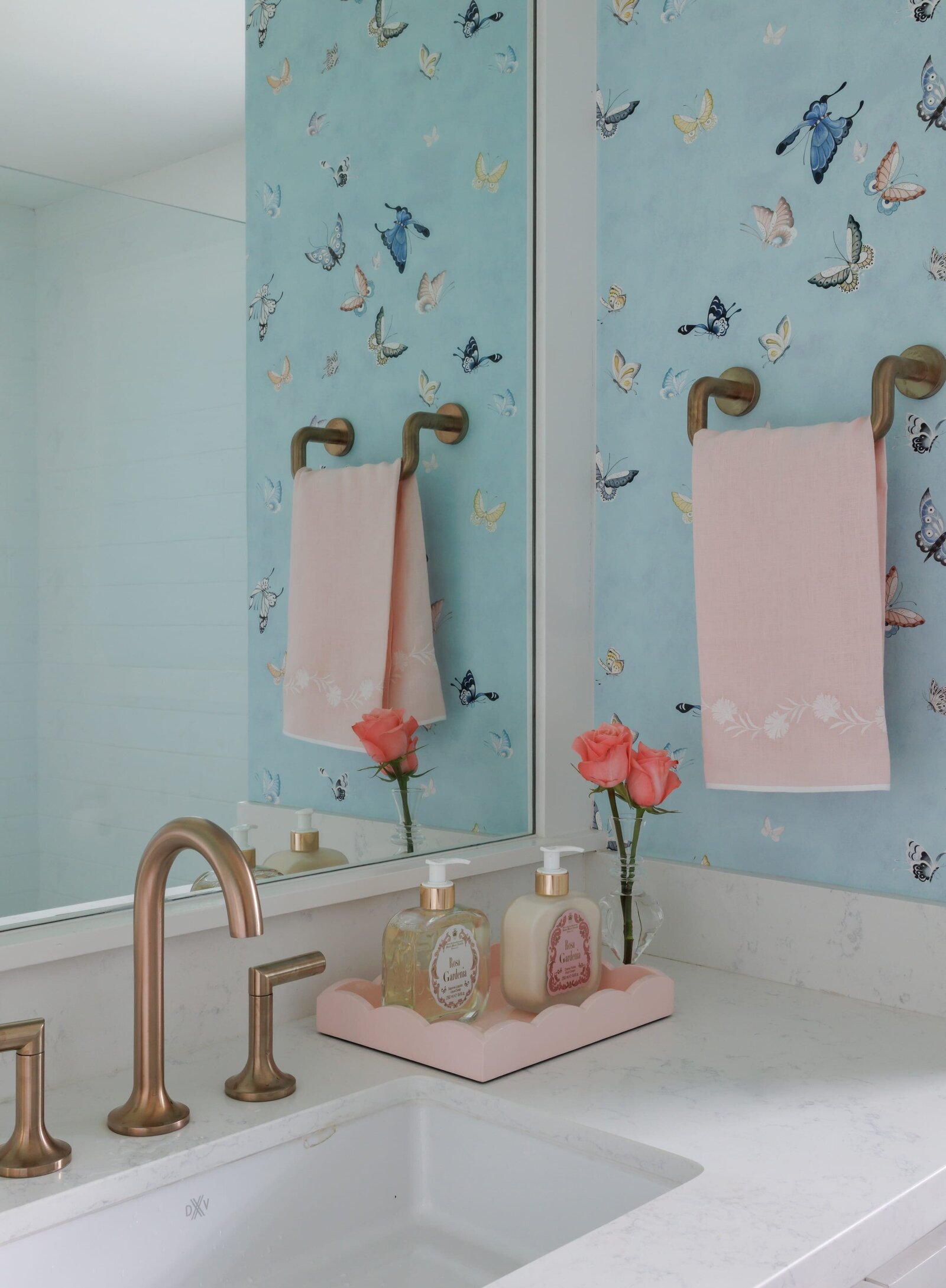 vision and hammer interior design bathroom with butterfly wallpaper and pink hand towel
