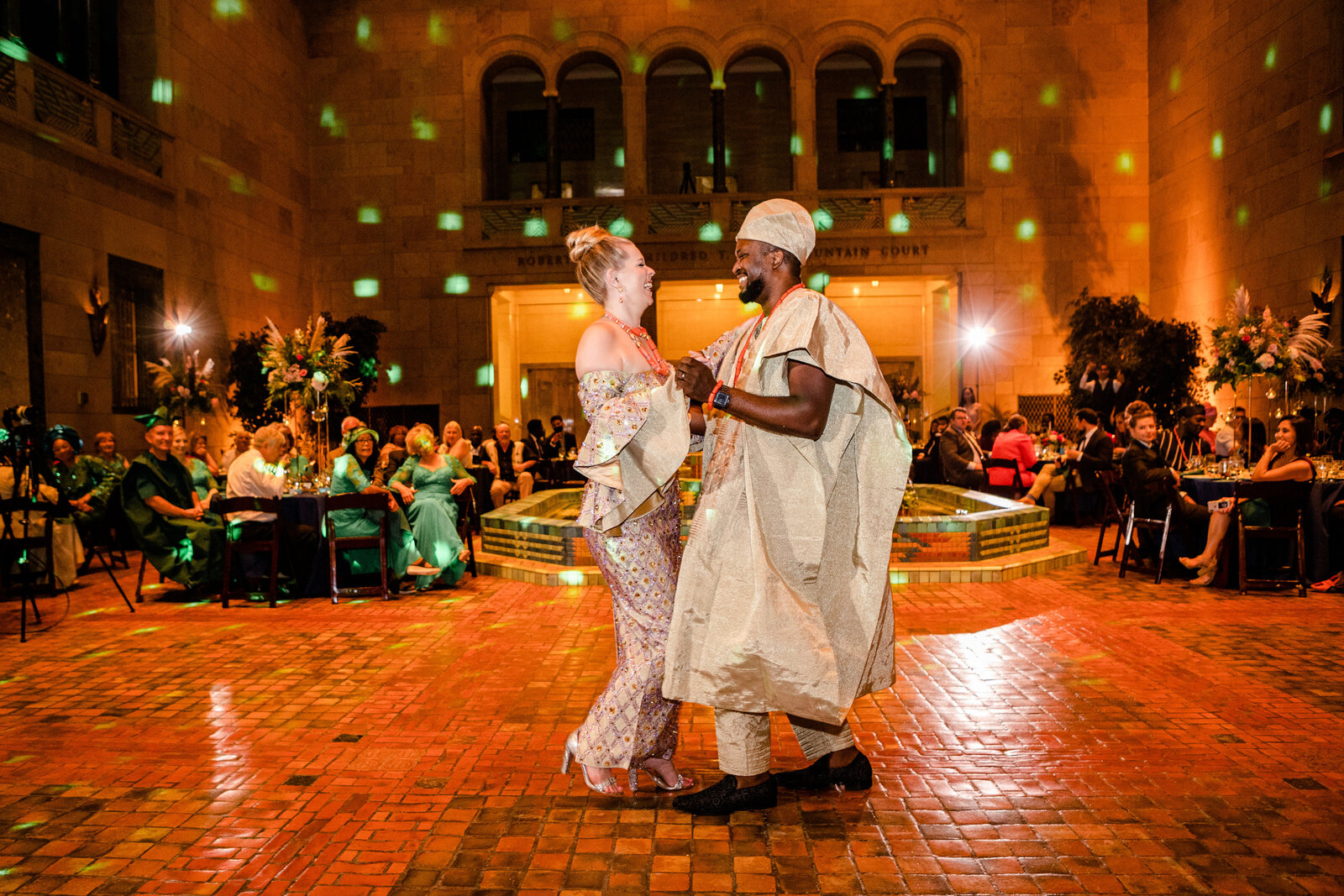 Bride and Groom dancing at Aso Ebi wedding with Agbada robe