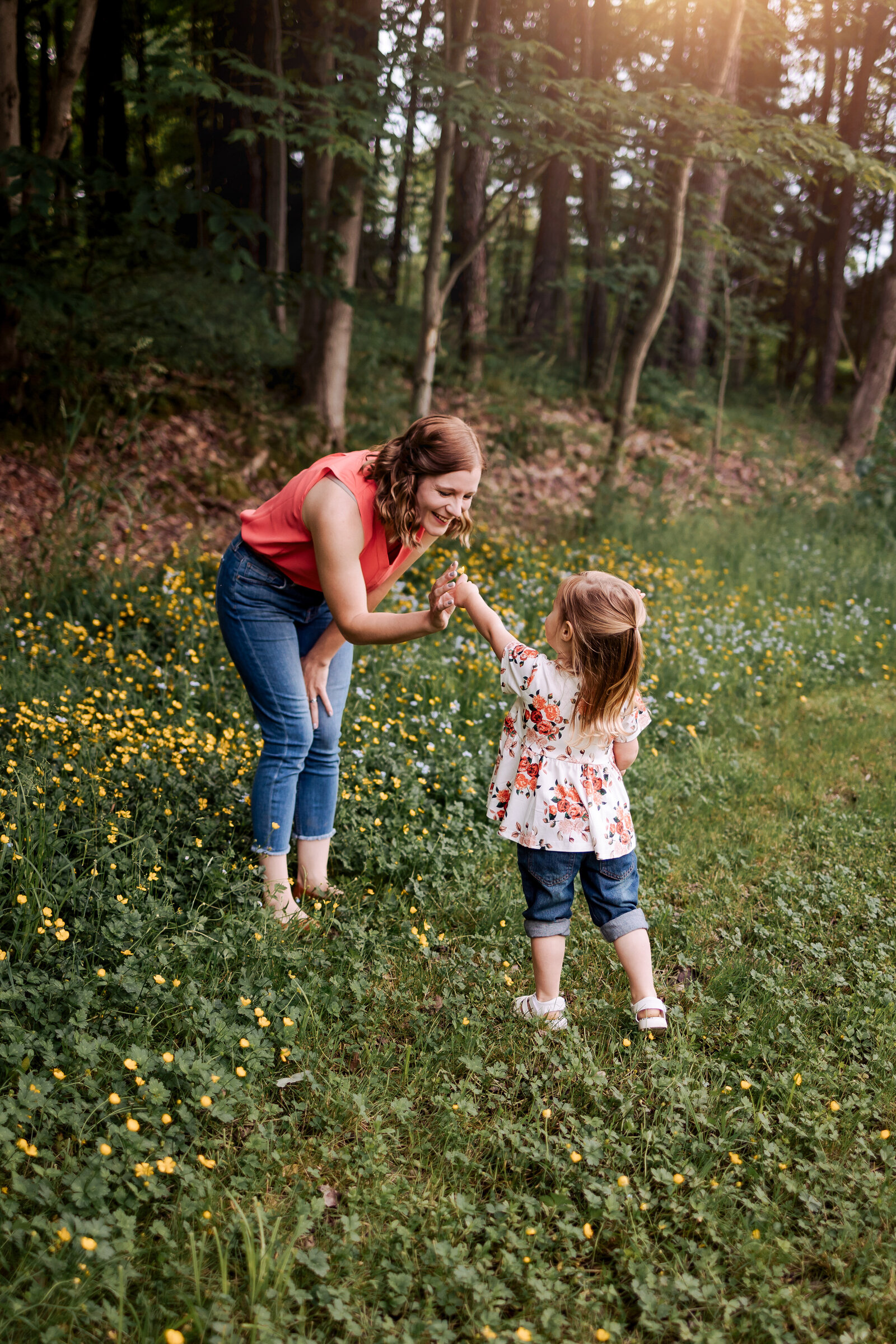 Little girl giving her mom a flower