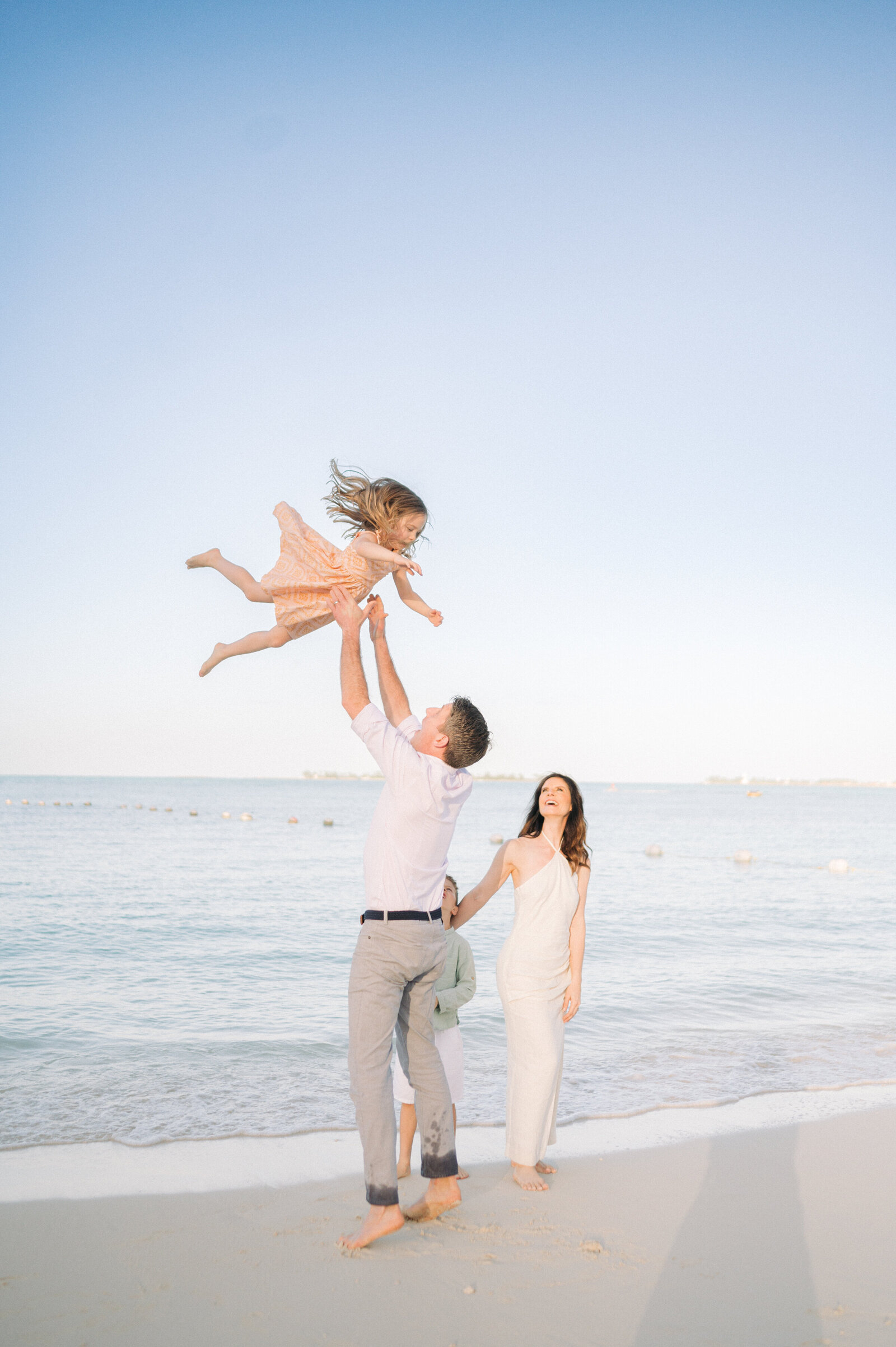 Family with small children holding hands on the beach at Grand Hyatt Baha Mar