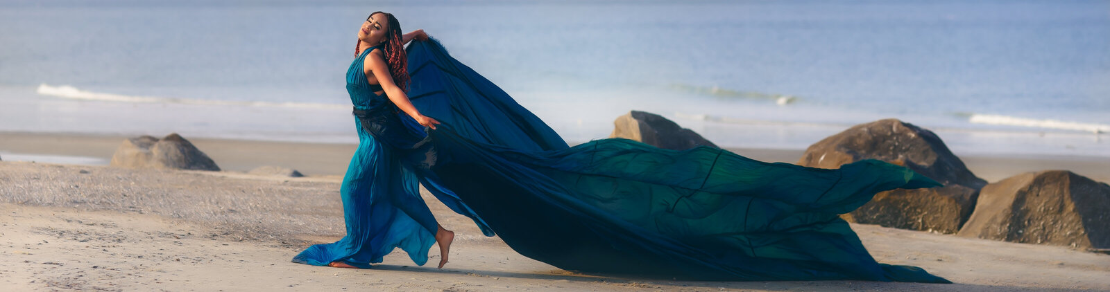 Savannah Boudoir Photography and Glamour showcases gorgeous black woman in blue parachute designer glamour gown on Tybee beach