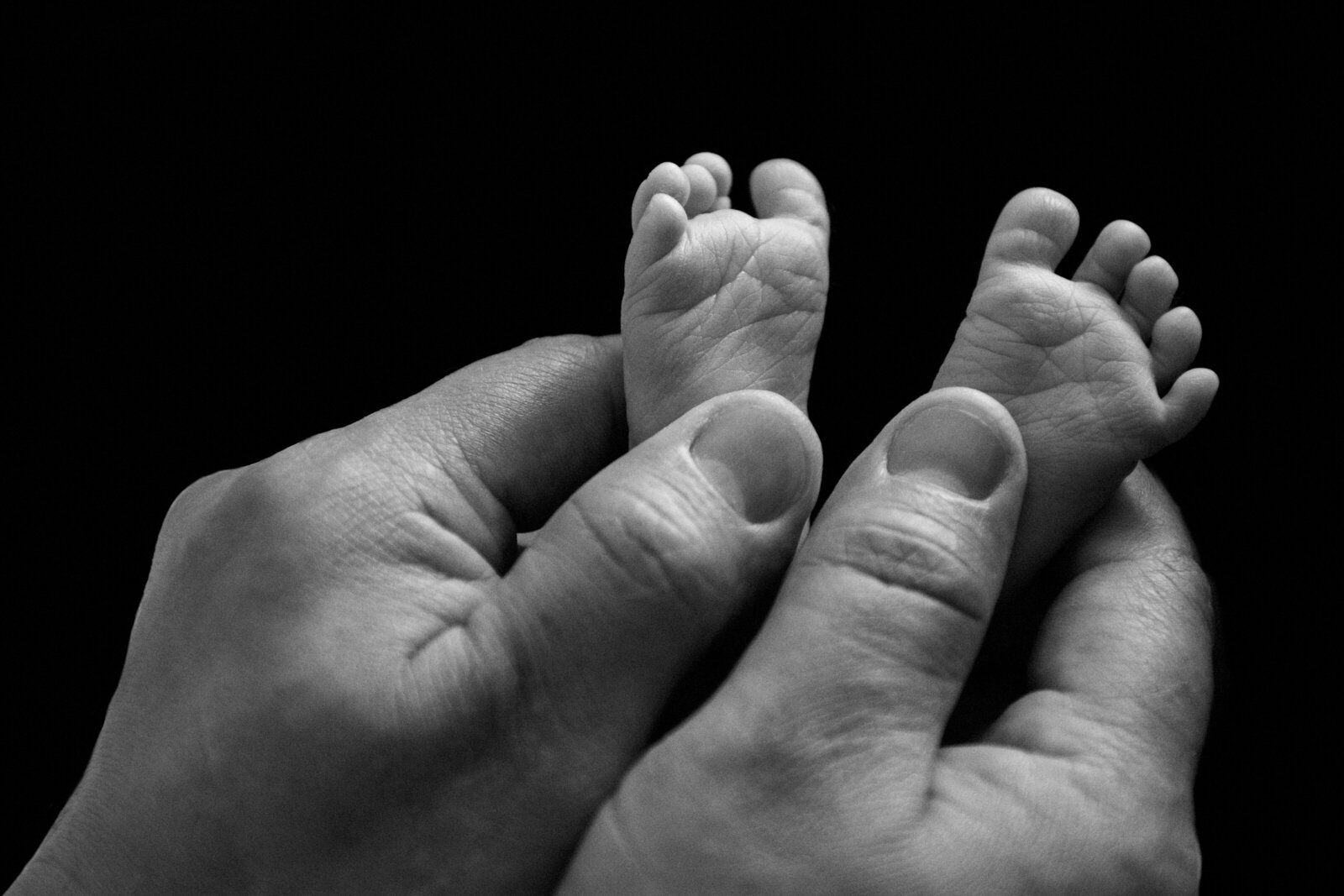 Baby Feet in her Father's hands