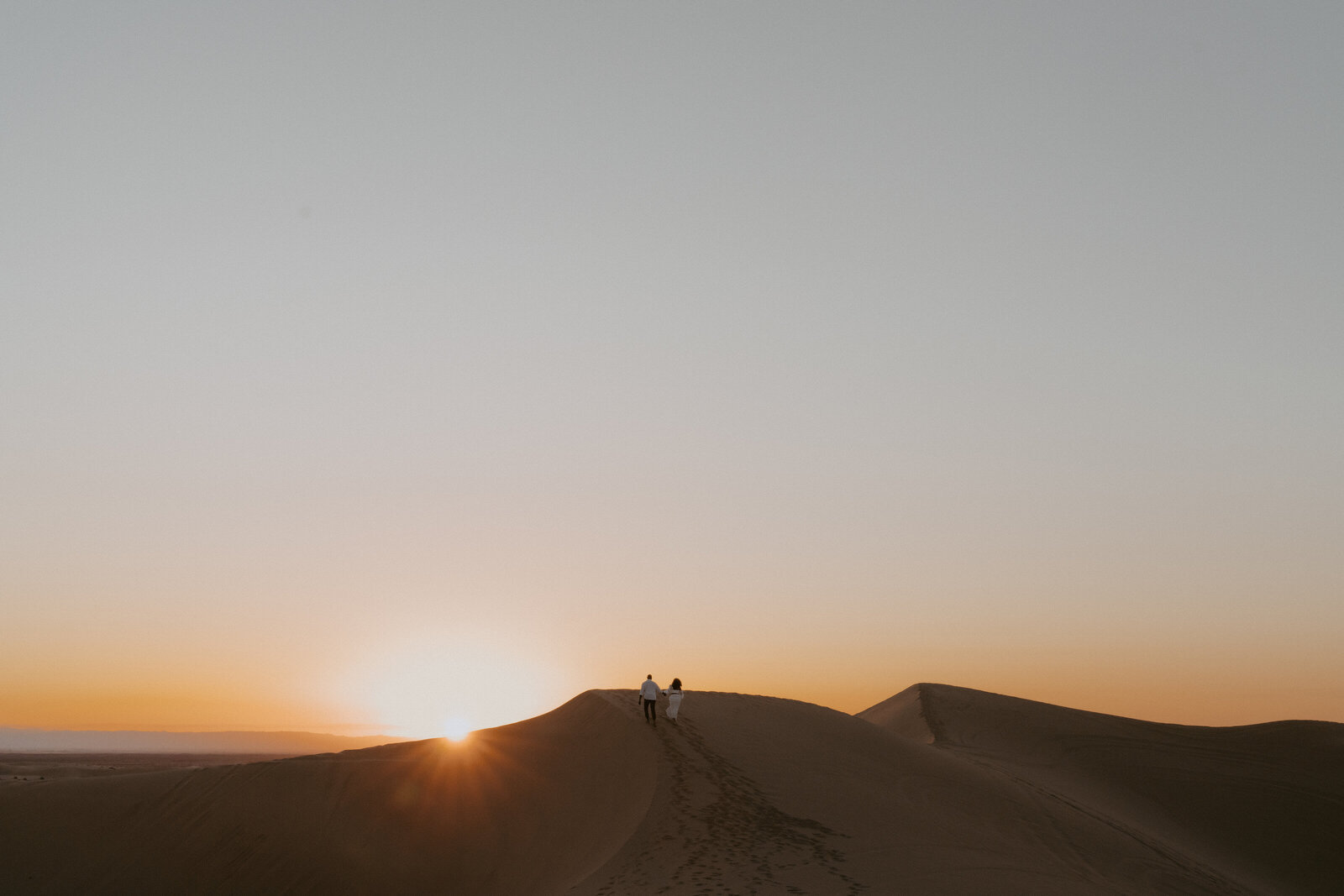 Couple eloping in the Imperial Sand Dunes in California at Sunset