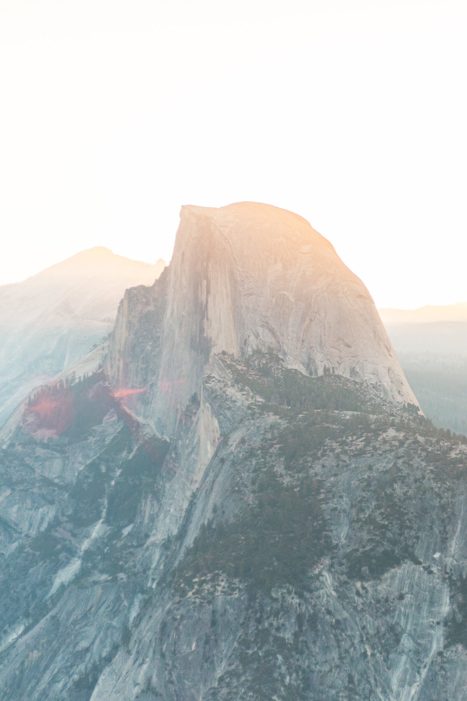 A wedding proposal between two hikers at sunrise in front of Half Dome in Yosemite National Park.