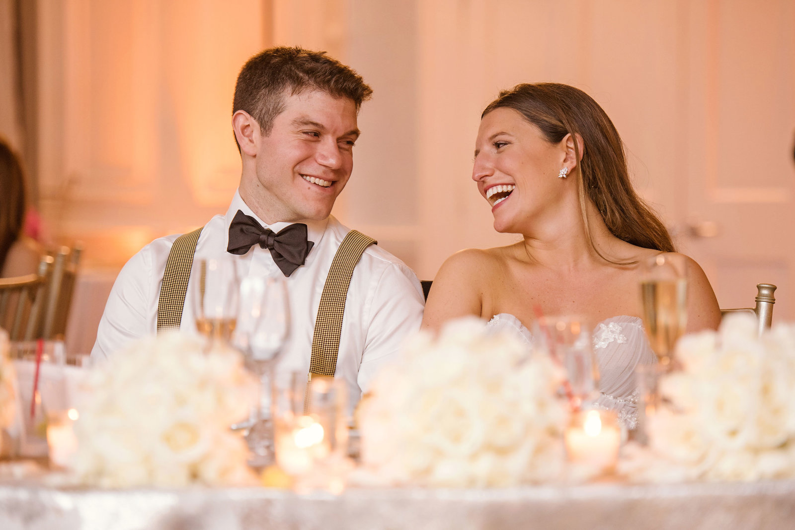 bride and groom laughing during the speeches at Glen Head Country Club