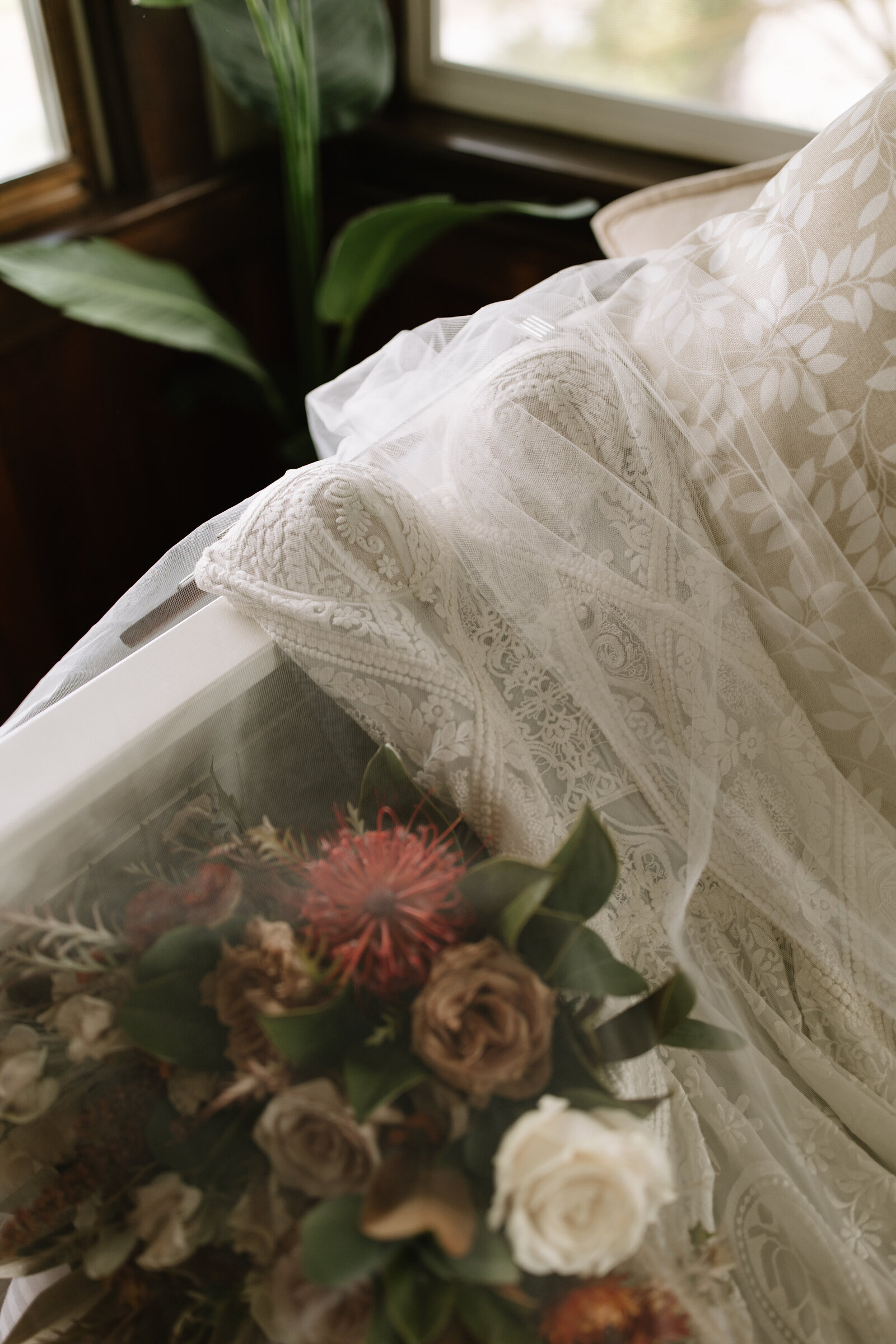 Bride's lace dress placed under veil in the bridal suite before Idaho wedding ceremony