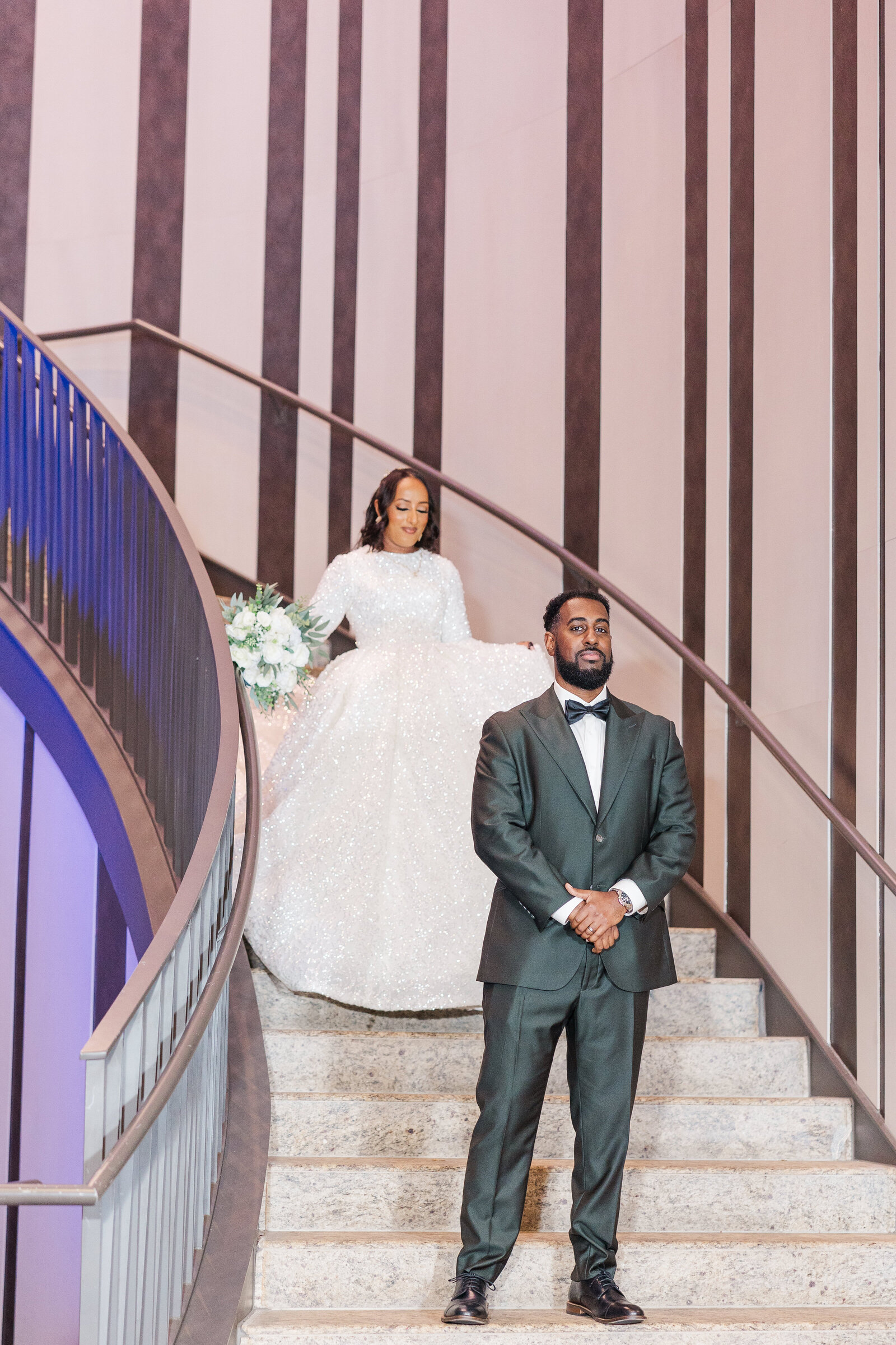 Bride walking down the stairs for first look 