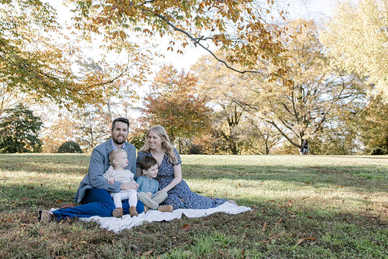 Family sitting together fall foliage