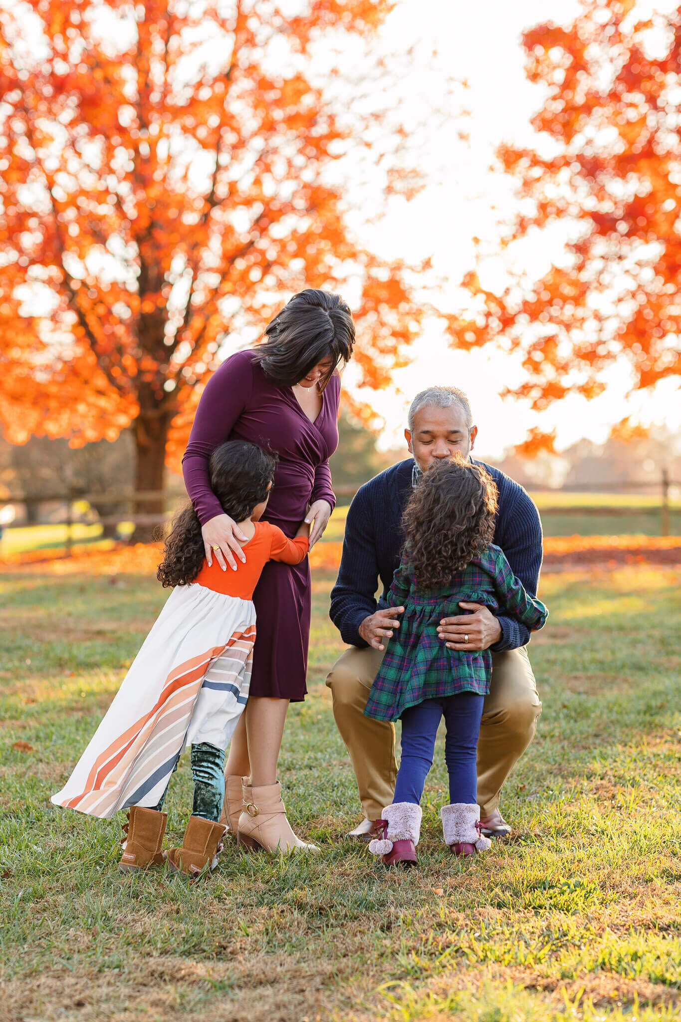 Two little girls hugging their parents