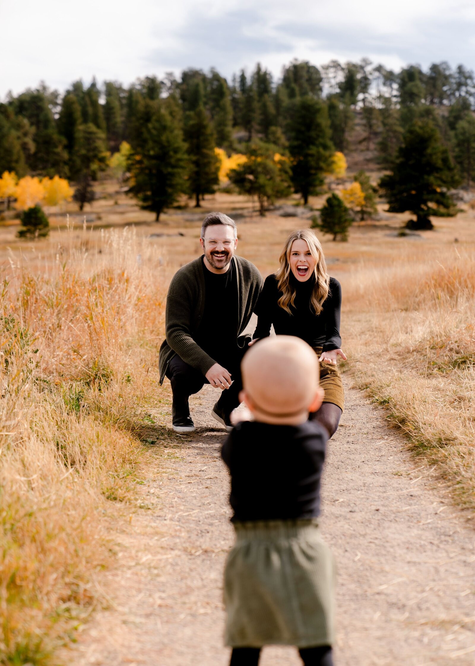 family photography - baby walking towards parents