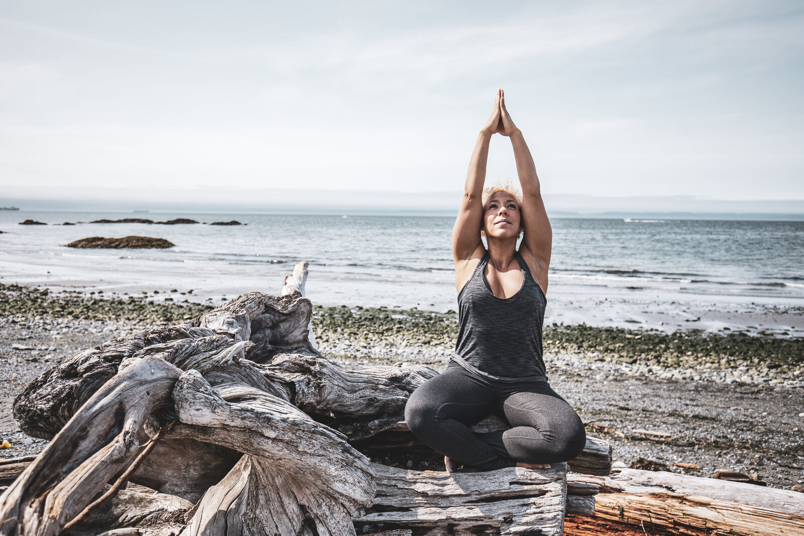 Woman doing yoga pose on beach