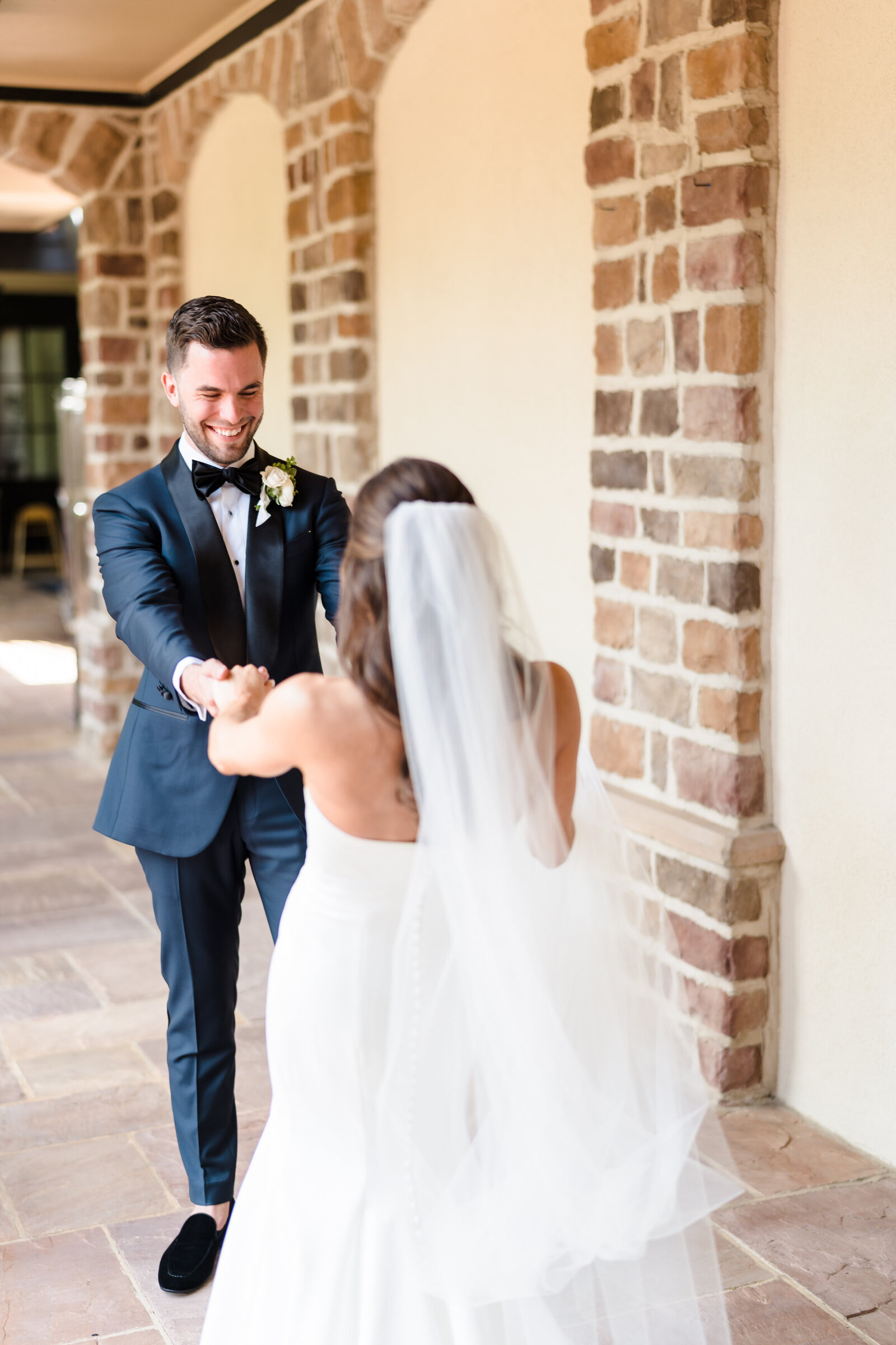 Groom smiles at his wife during their first look at Pinnacle Golf Club