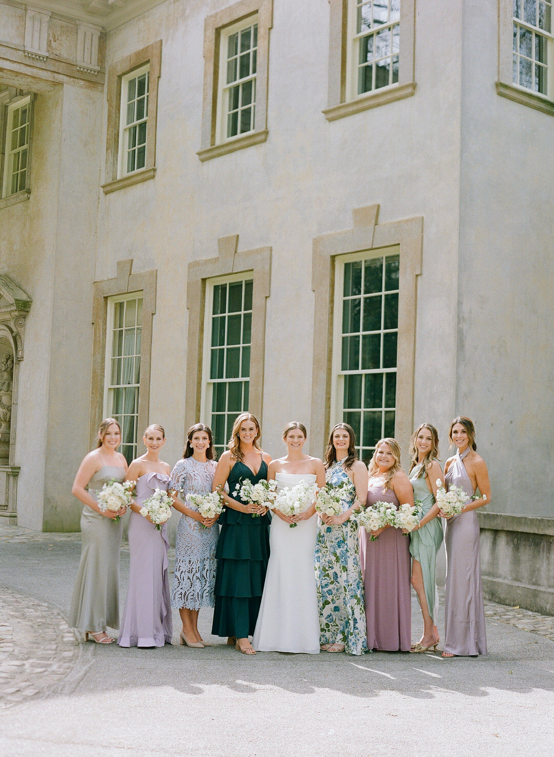 Bride with Bridesmaids in different pattern dresses at The Swan House