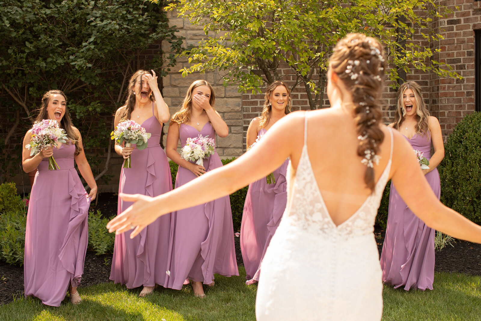 Bride has a first look with her bridesmaids on wedding day at Blue Heron Brewery & Event Center. Photo taken by Aaron Aldhizer