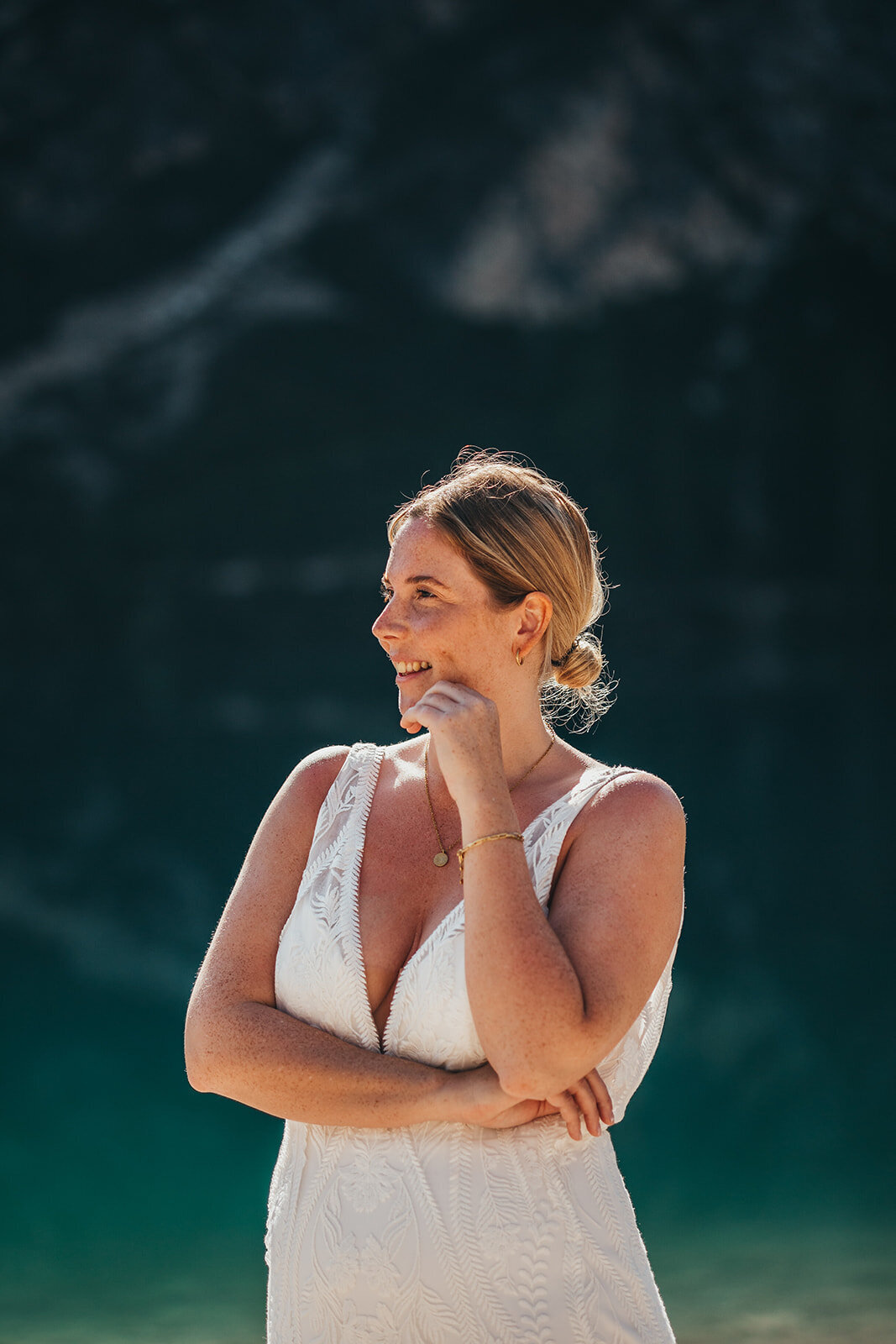 bride poses by lake