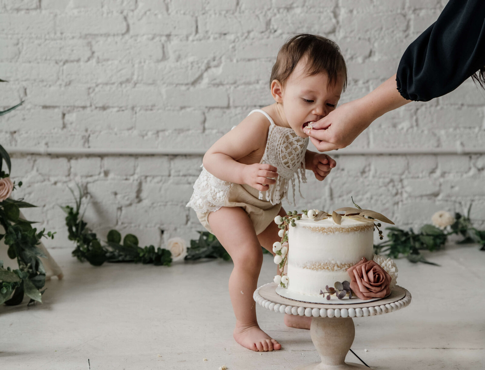 Little baby eating cake.