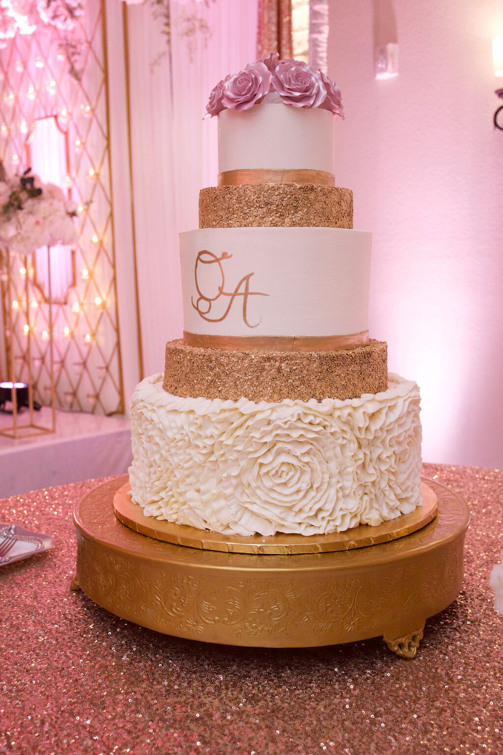 five tier gold and white wedding cake with pink roses