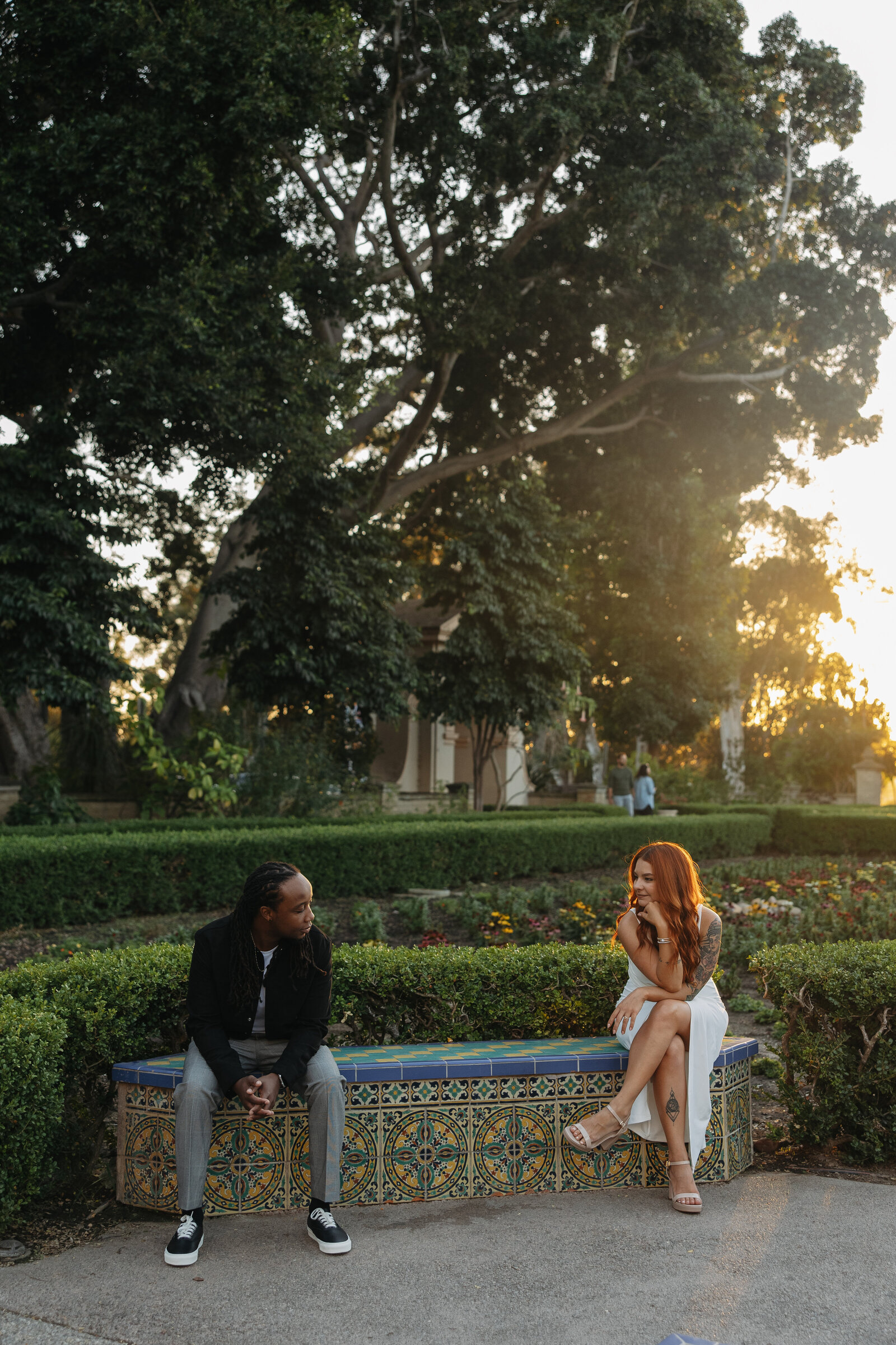 couple sitting on bench during sunset