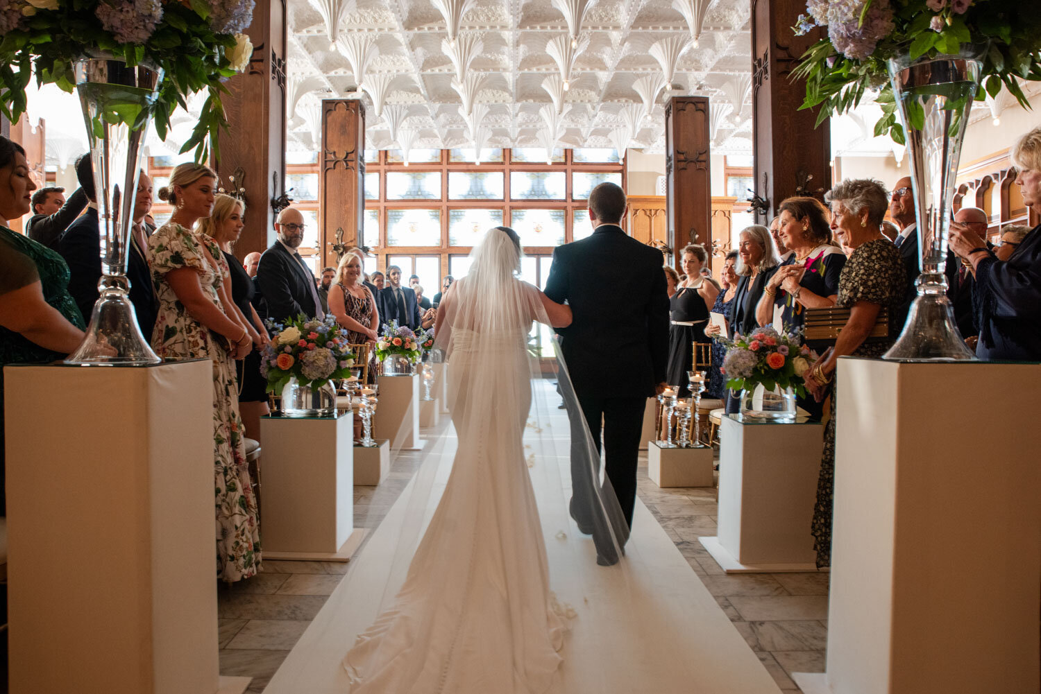 A bride and groom are walking down the aisle at their wedding