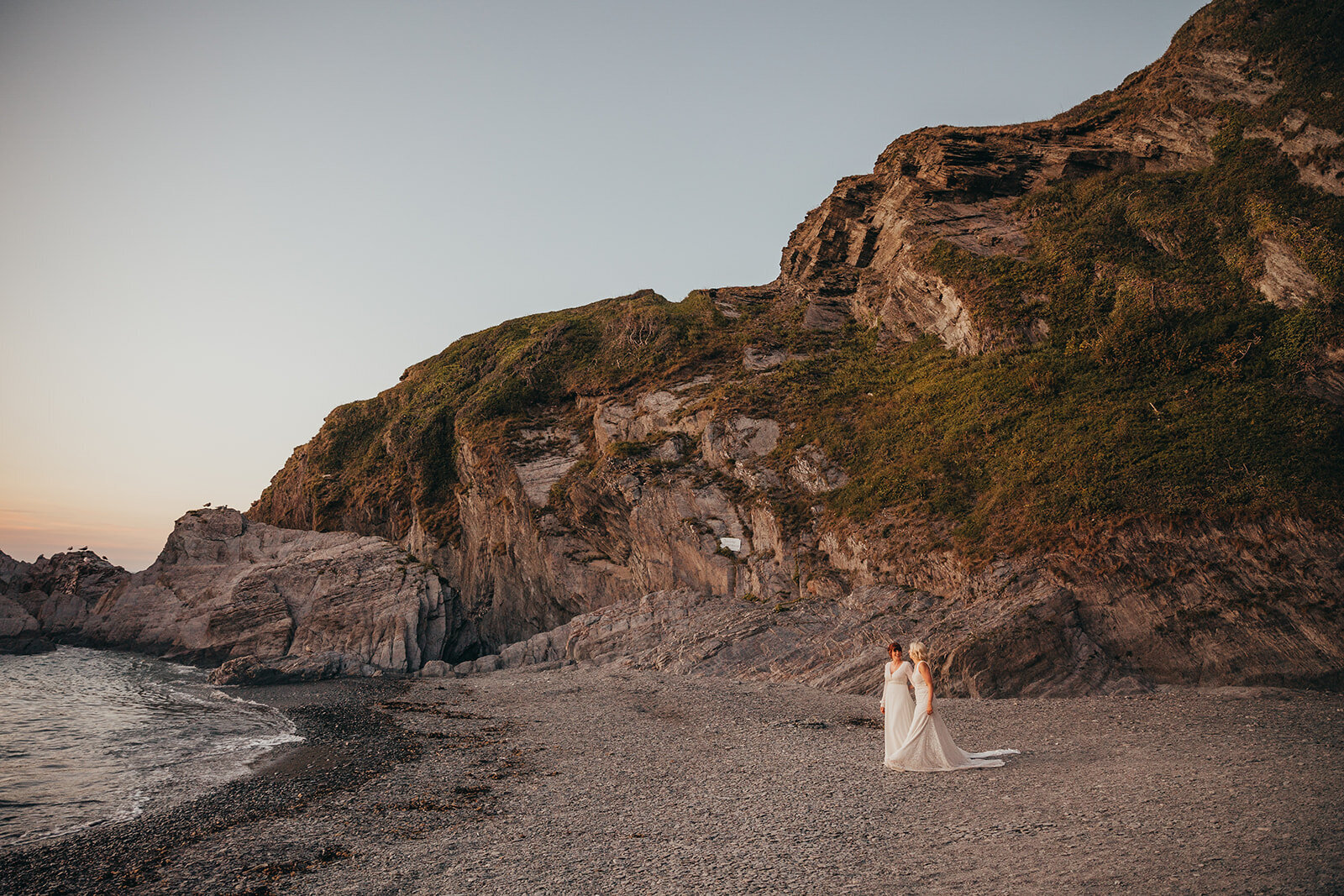 female married couple on beach