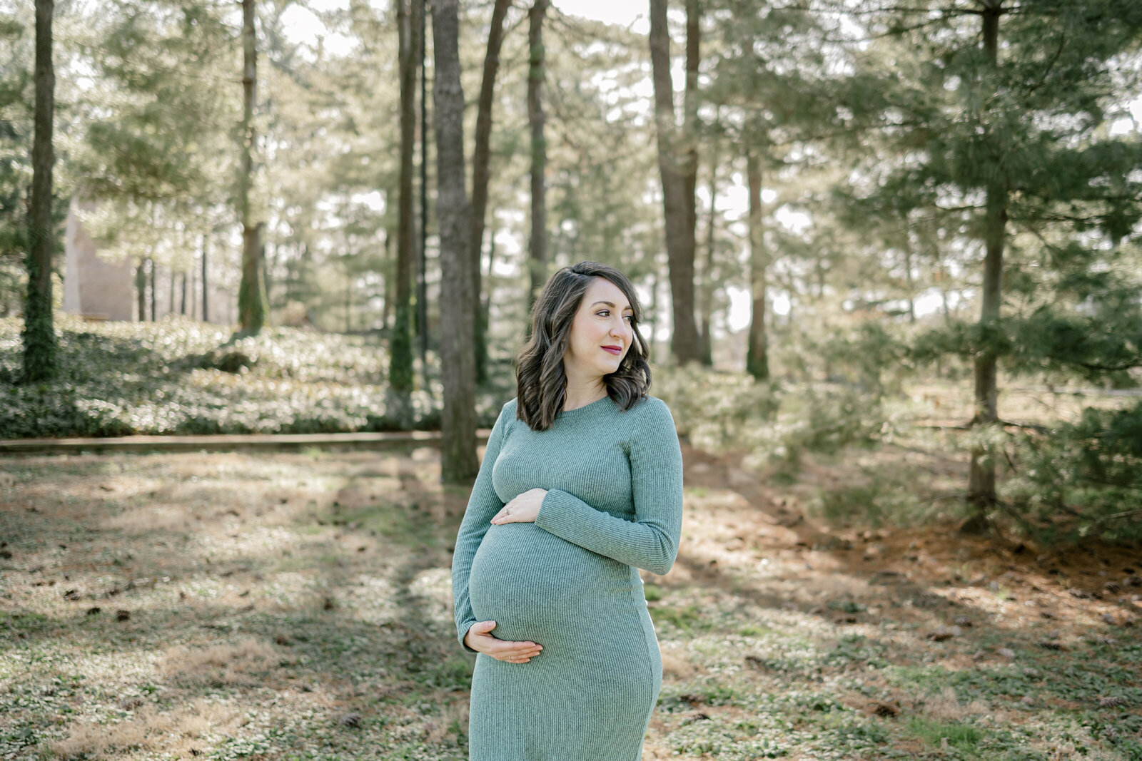 Pregnant woman in field of trees