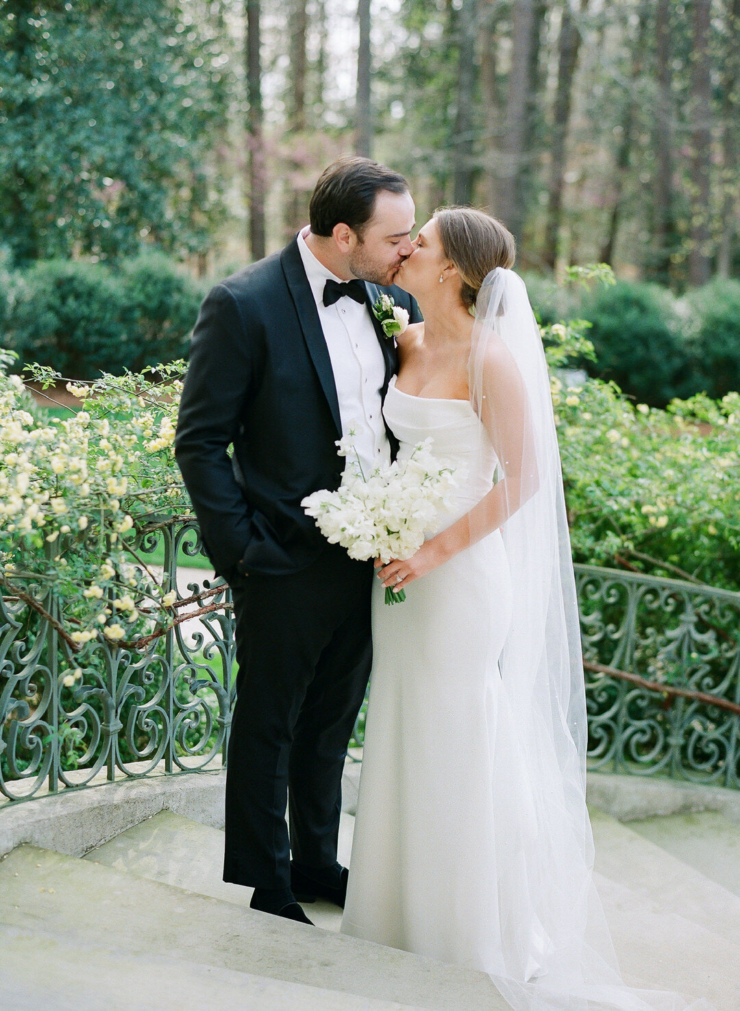 Bride and Groom Kissing on Stairs at The Swan House in Atlanta