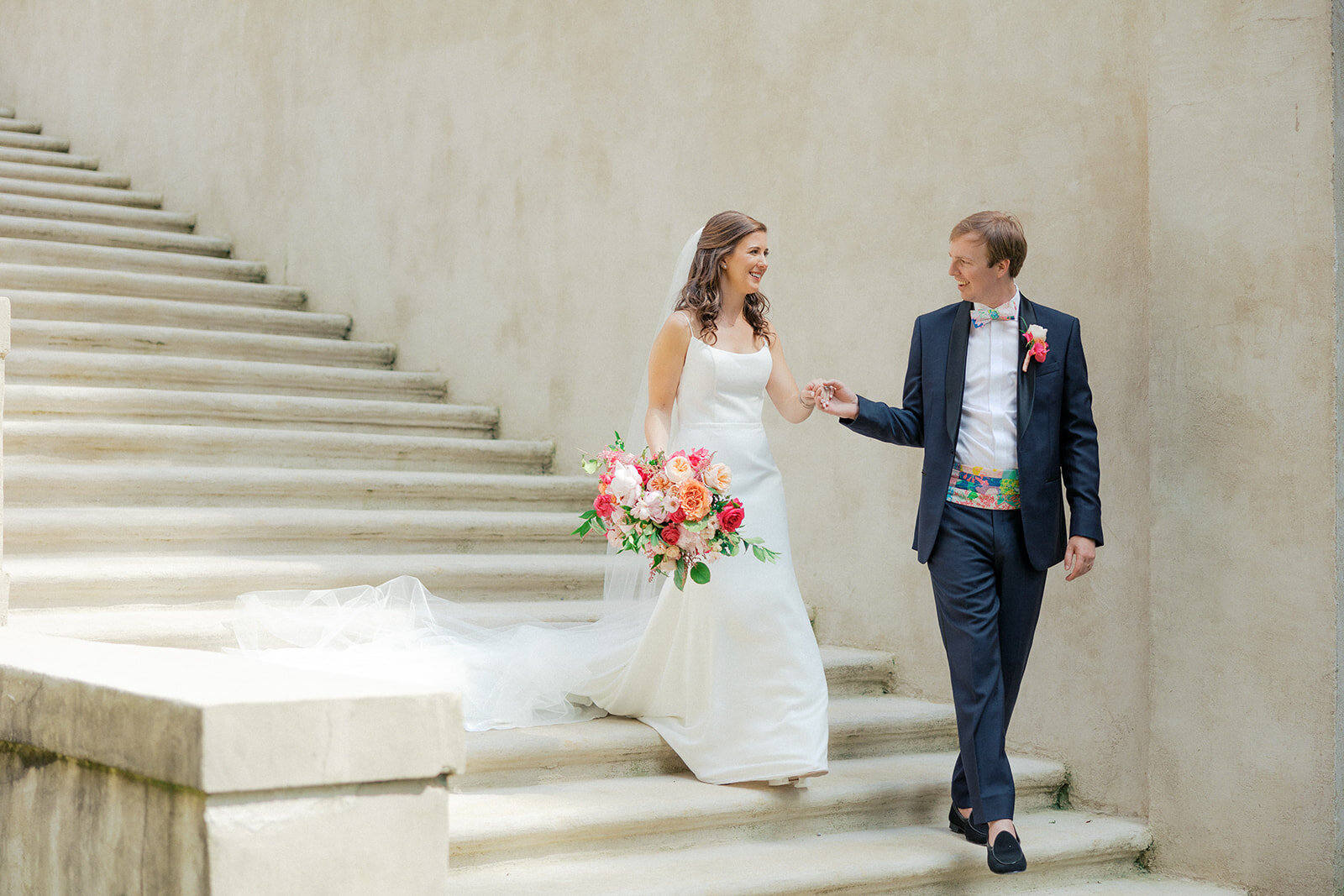 bride and groom walking down fountain steps at the swan house