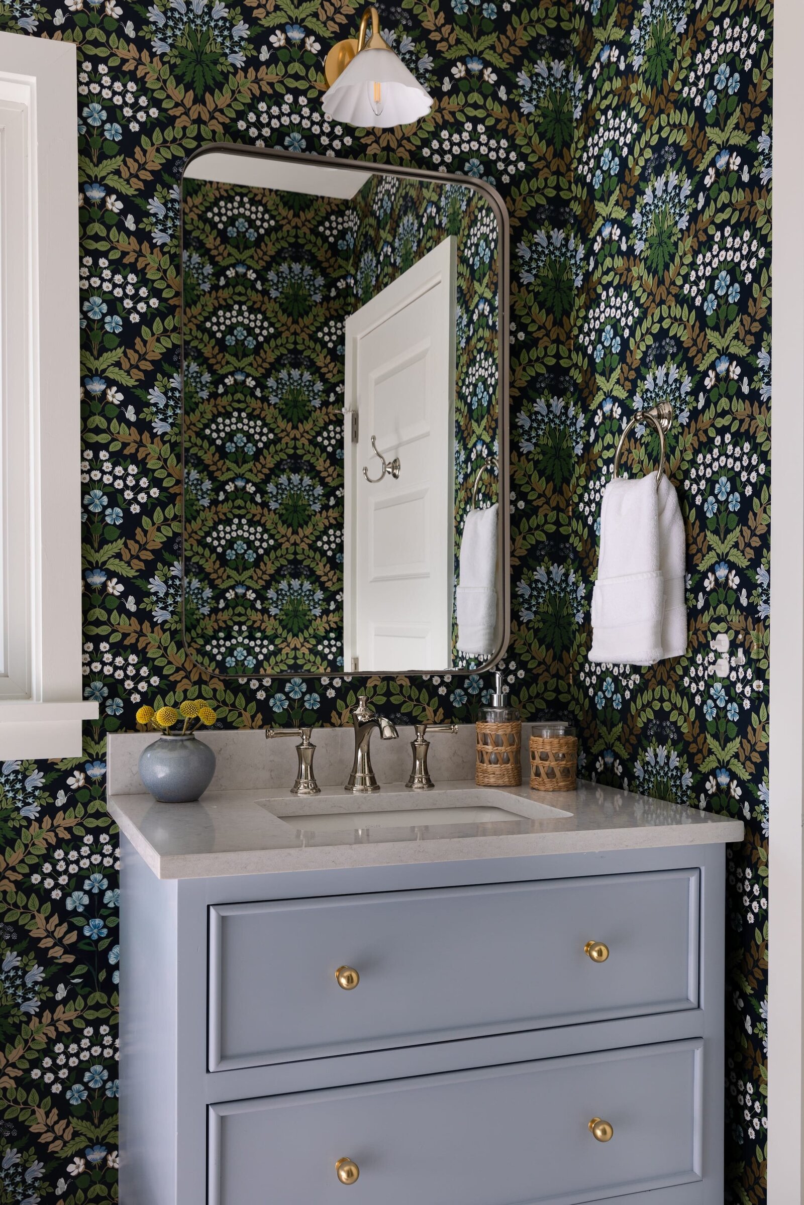 melinda chesson interiors murrayhill road accent wallpaper and blue vanity in bathoom