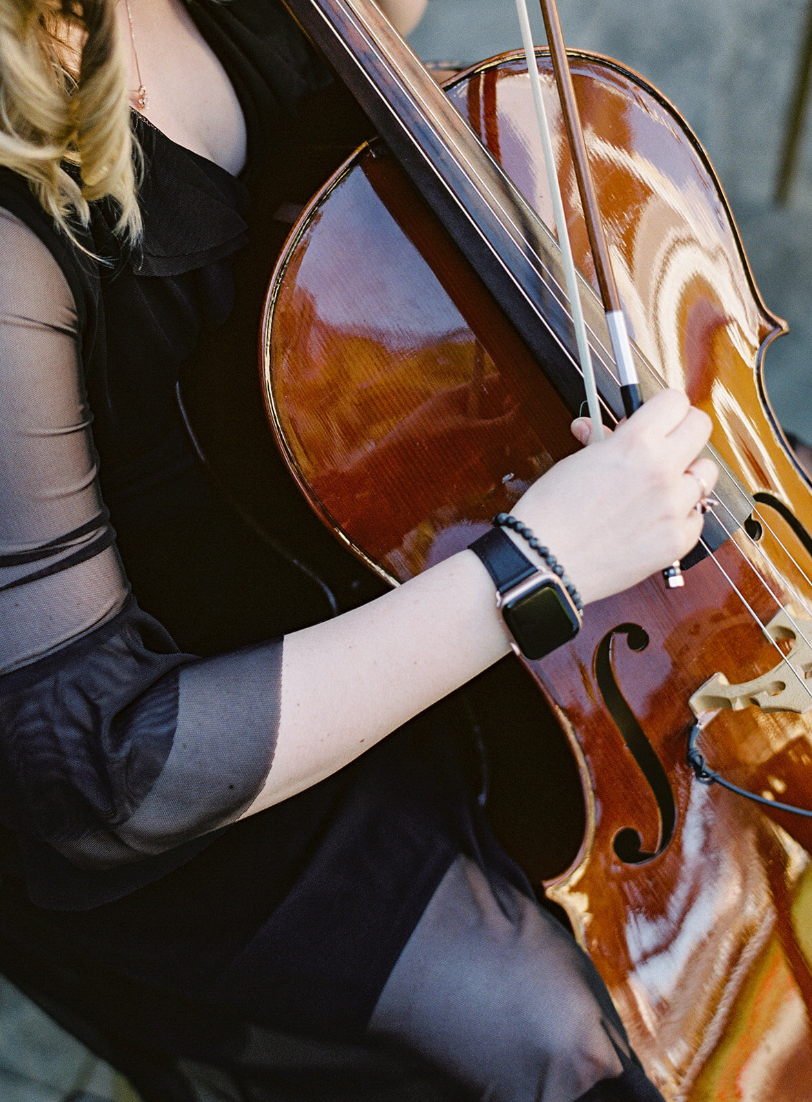 Close up of cellist at wedding. Photographed by wedding photographers in Charleston Amy Mulder Photography.