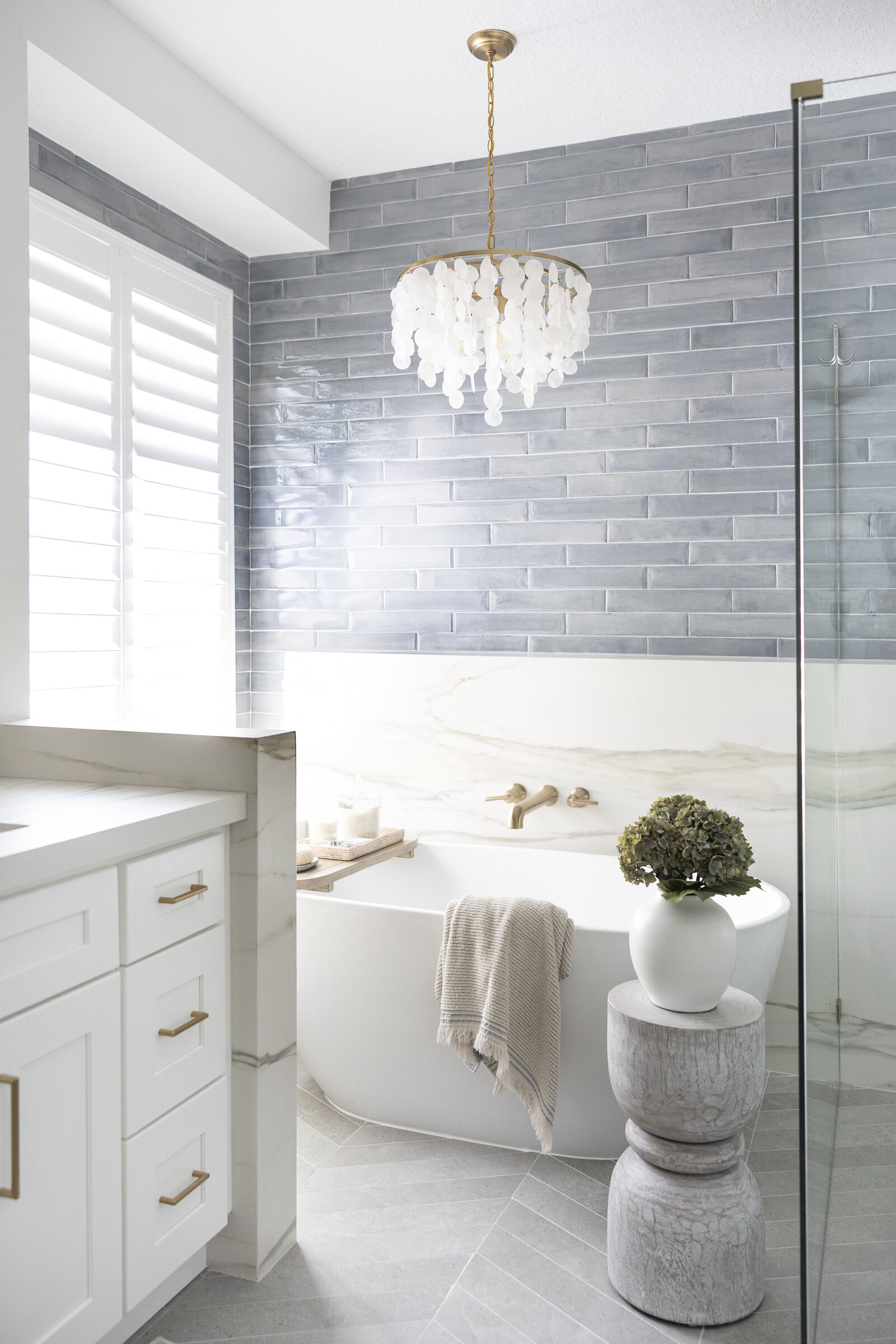 dewine design interiors contemporary coastal primary bath chandelier gray tile