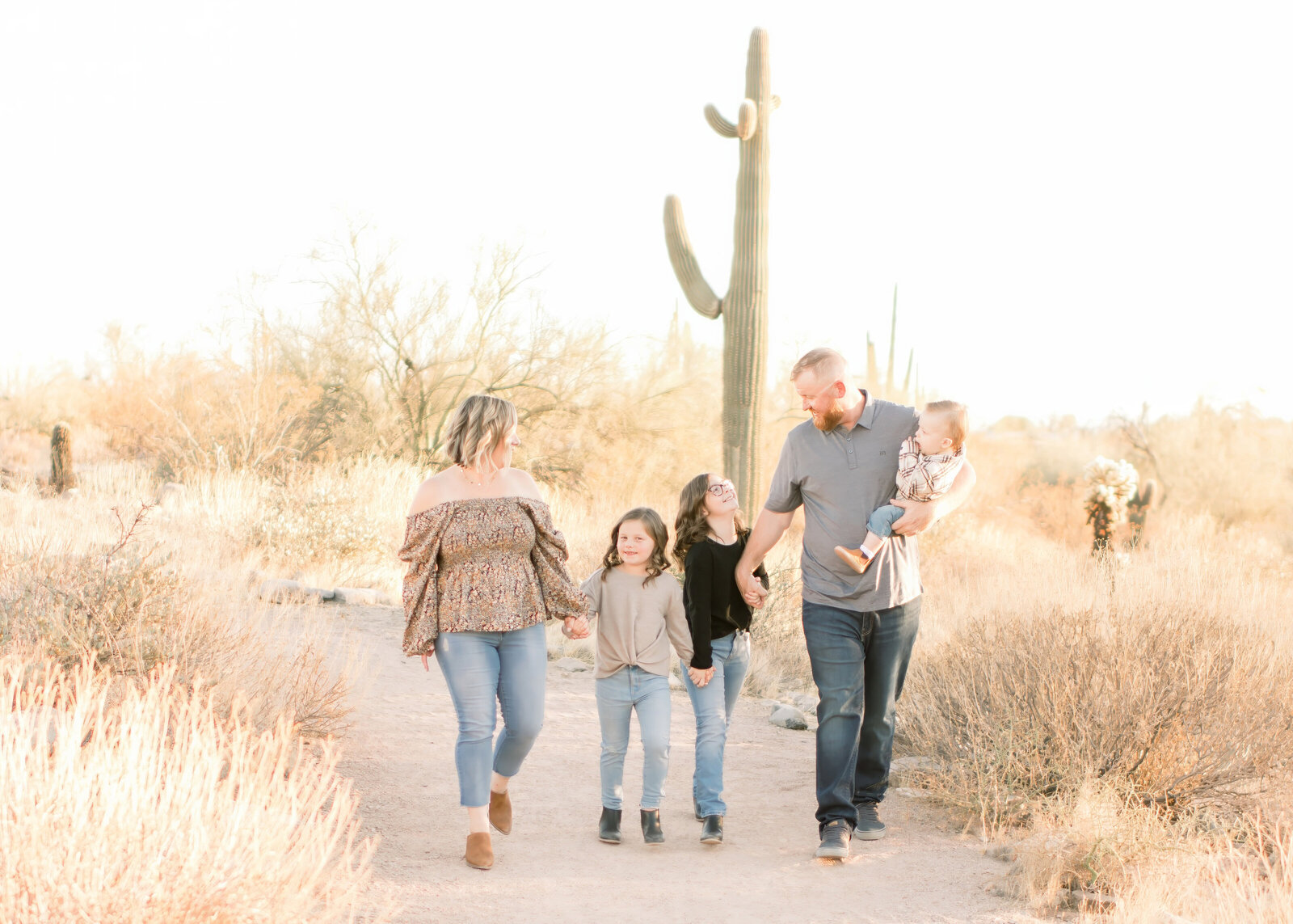 family of 5 walking for family photos in the north scottsdale az