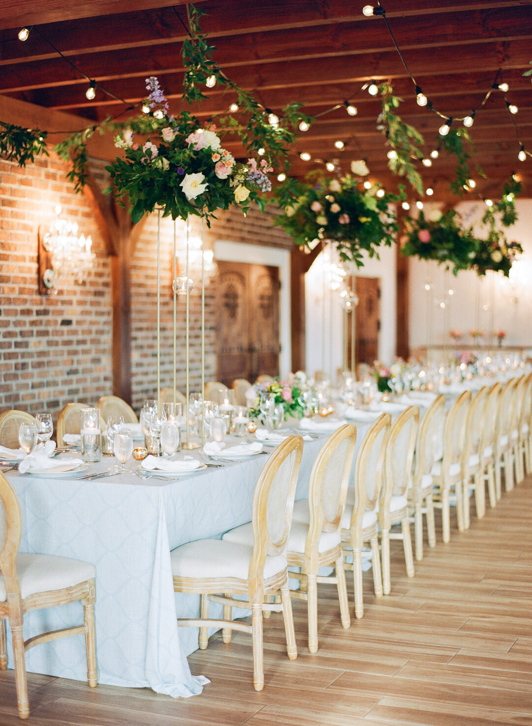 wedding reception head table with flowers and candles