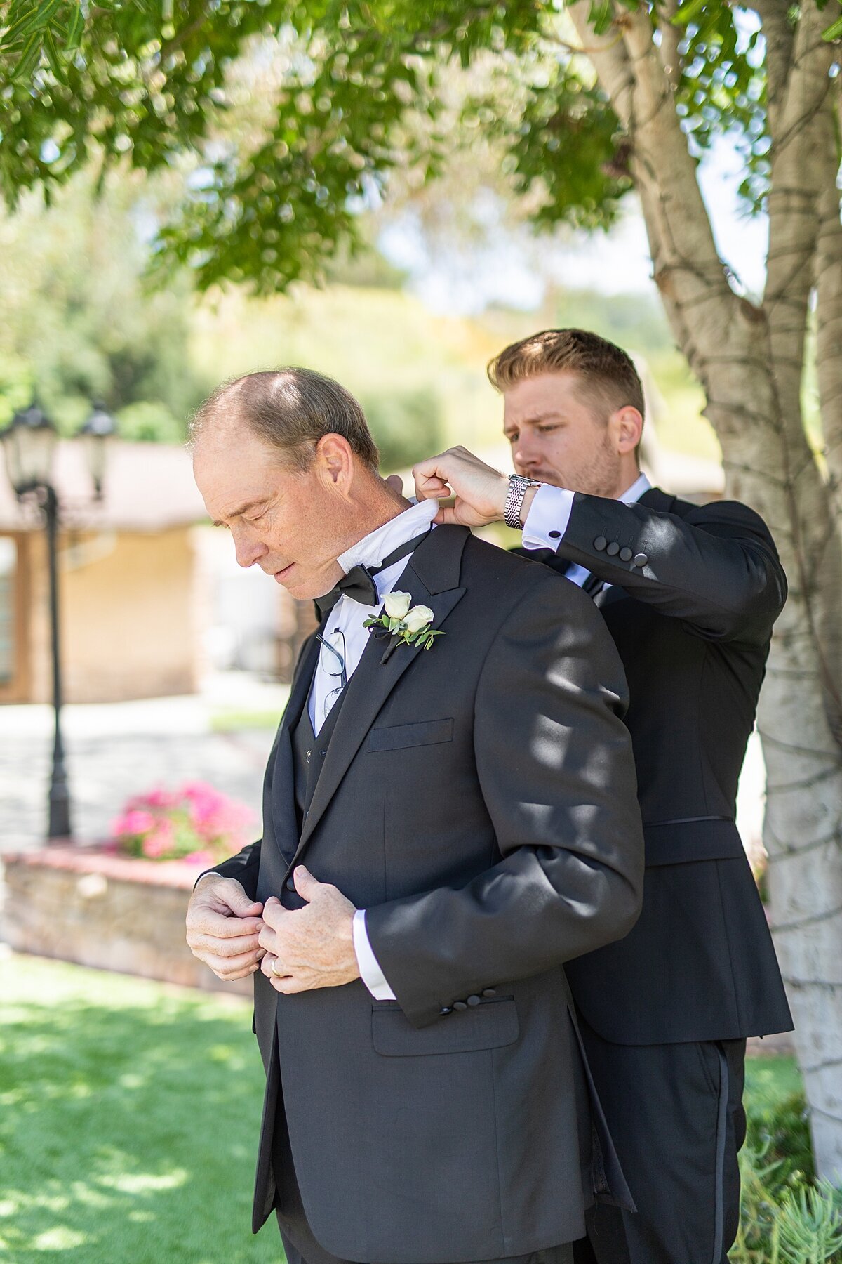 Groom getting on his father's bowtie at Los Willows Wedding venue.