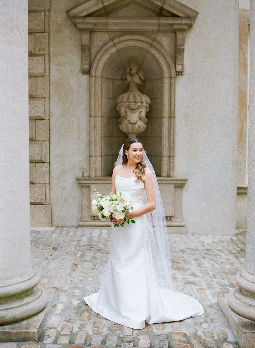 Bride Looking over shoulder holding bouquet at Swan House in Atlanta Georgia