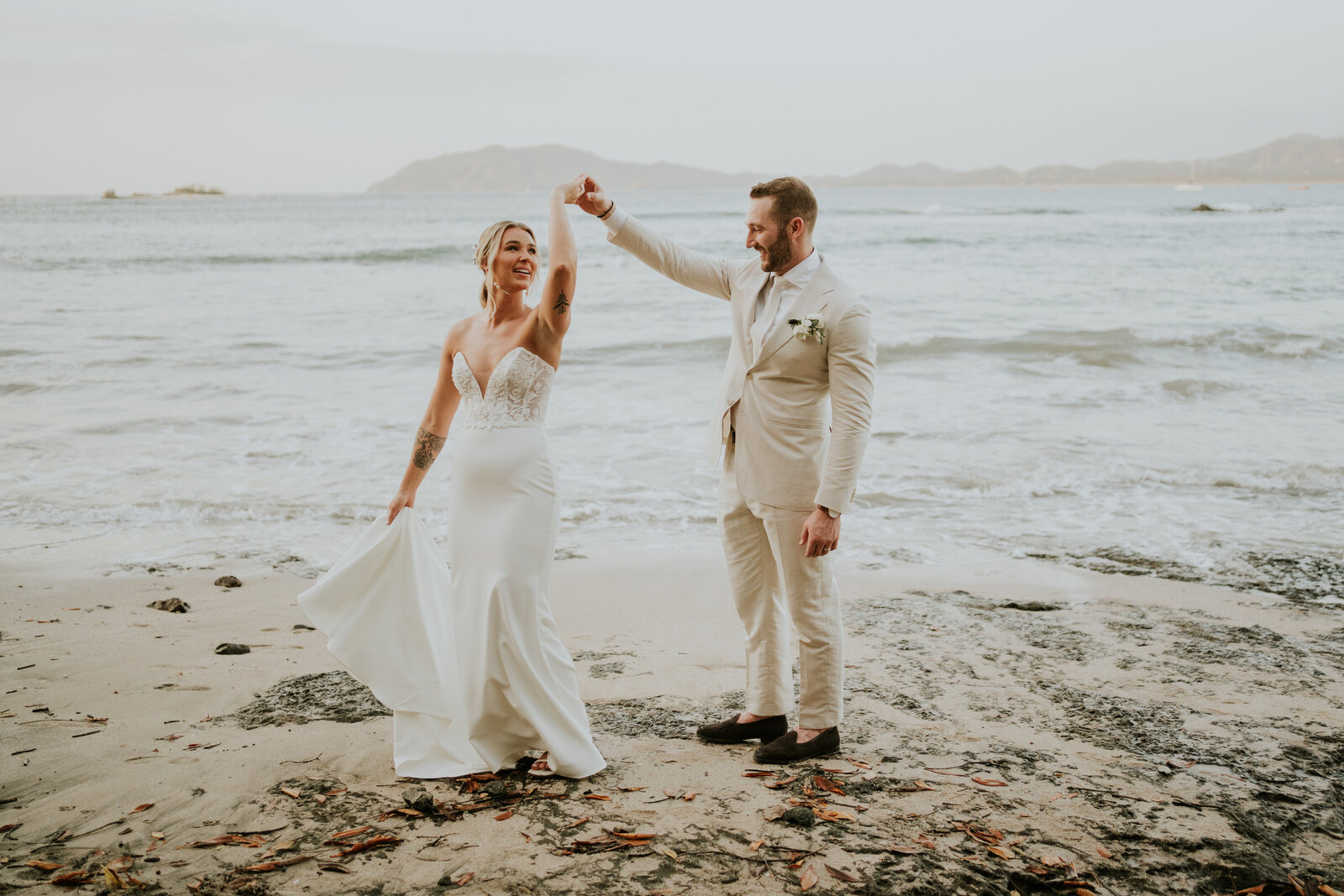 wedding couple standing in front of vineyards