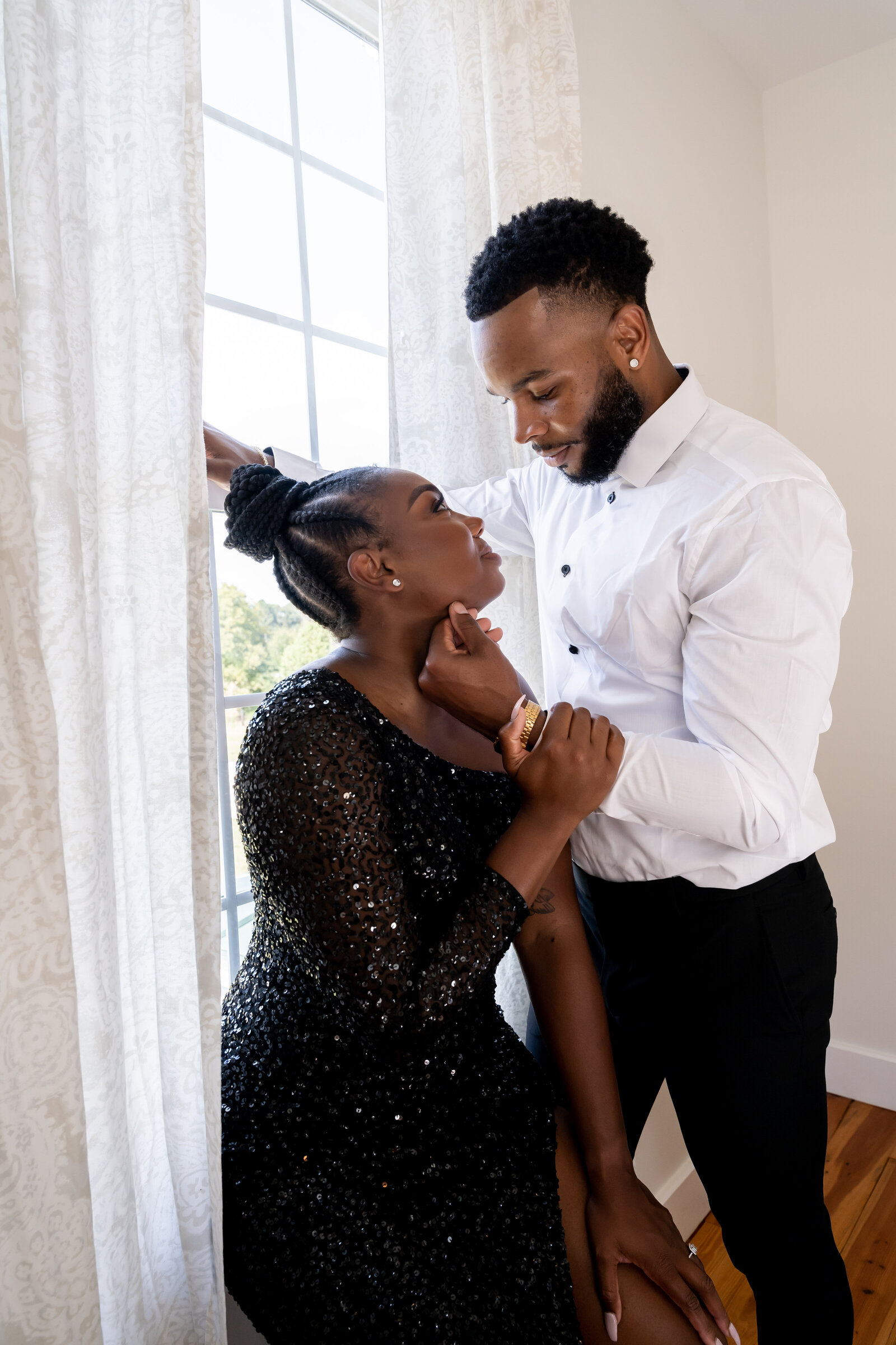 Engagement photoshoot, man wearing black and white suit, woman wearing black sequin dress