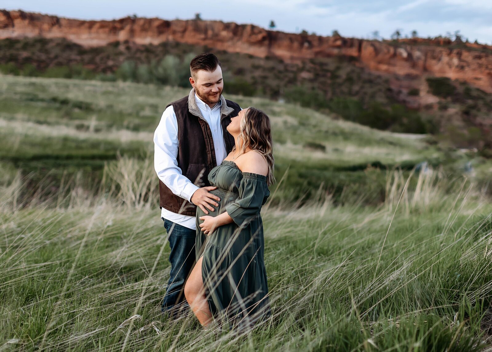 loving vouple in front of mountains in denver for pregnancy photos