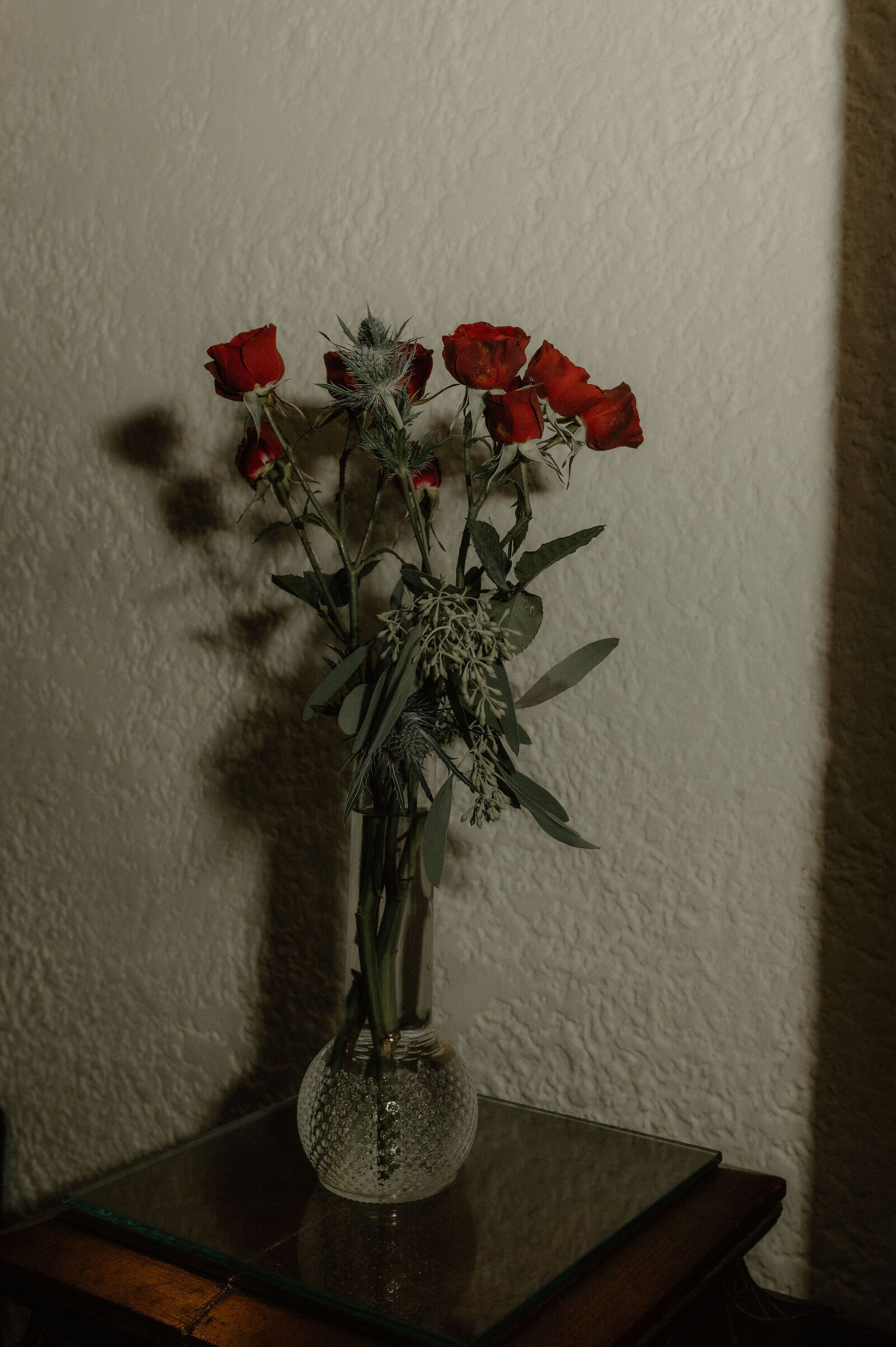 crystal and red roses in a flash photo